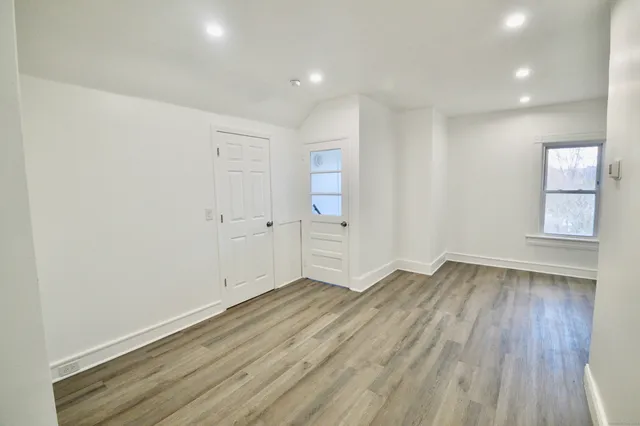 wooden floor in an empty room with a window
