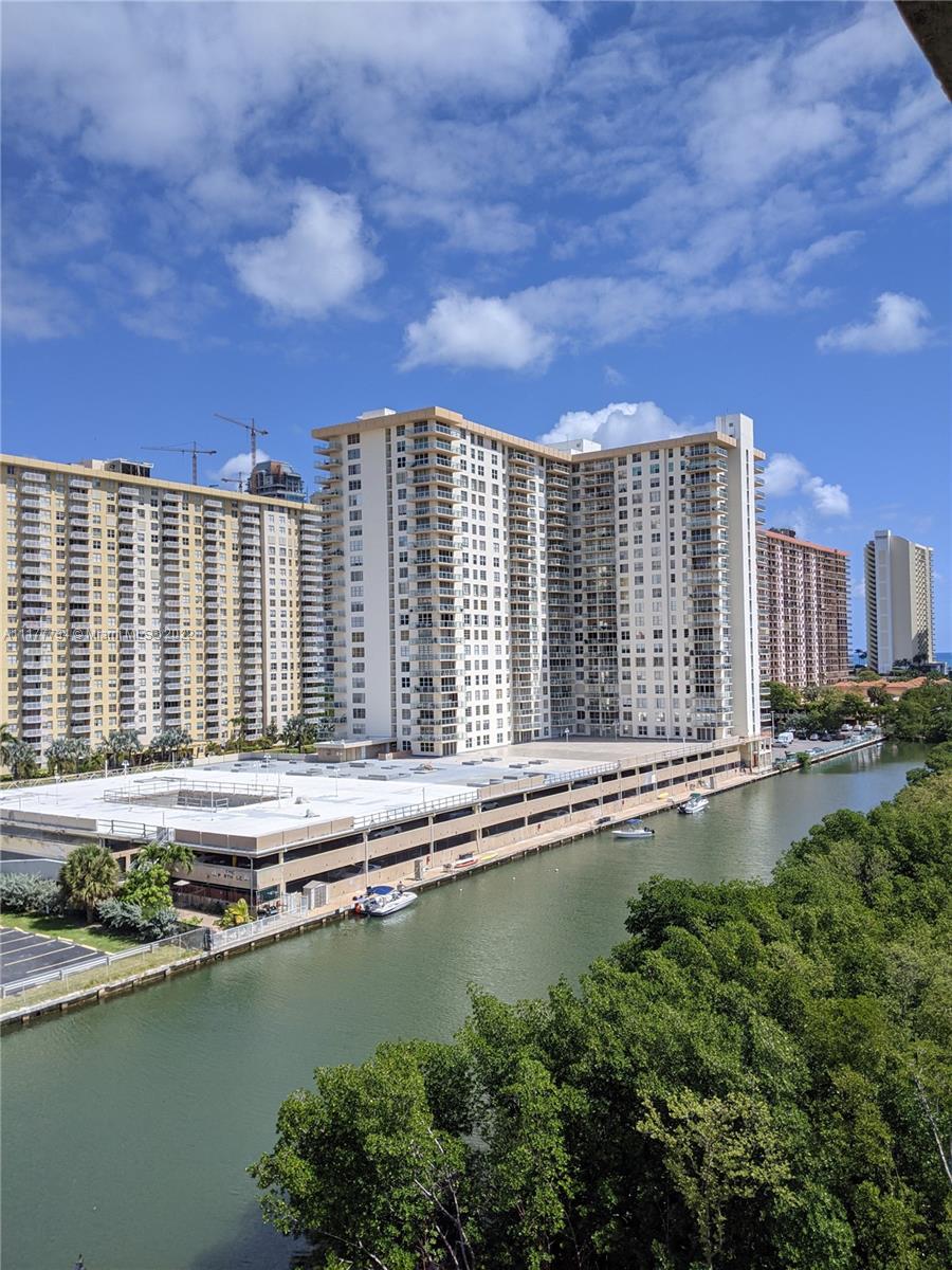 17150 North Bay Road, Unit 2814 Sunny Isles Beach, FL 33160 - Photo 16 of 25 a view of a large building with a big yard and large trees