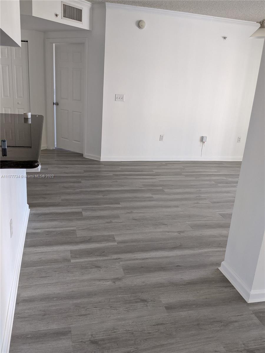 17150 North Bay Road, Unit 2814 Sunny Isles Beach, FL 33160 - Photo 19 of 25 a view of room with wooden floor