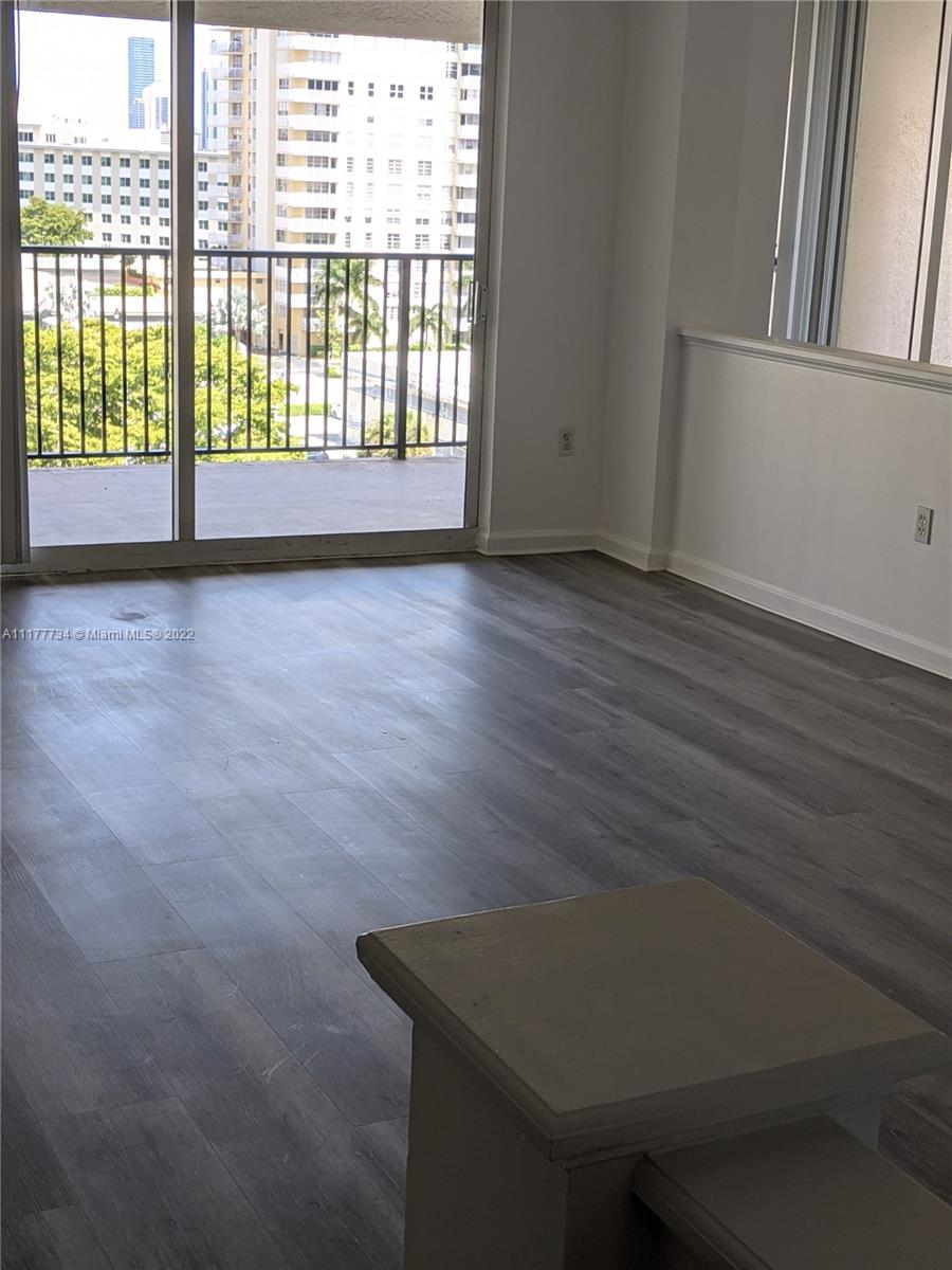 17150 North Bay Road, Unit 2814 Sunny Isles Beach, FL 33160 - Photo 20 of 25 a view of an empty room with wooden floor and a window