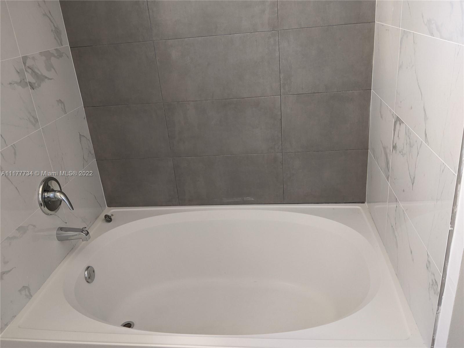 17150 North Bay Road, Unit 2814 Sunny Isles Beach, FL 33160 - Photo 21 of 25 a white bath tub sitting in a bathroom