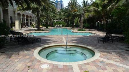 17150 North Bay Road, Unit 2814 Sunny Isles Beach, FL 33160 - Photo 10 of 25 a swimming pool with outdoor seating and yard
