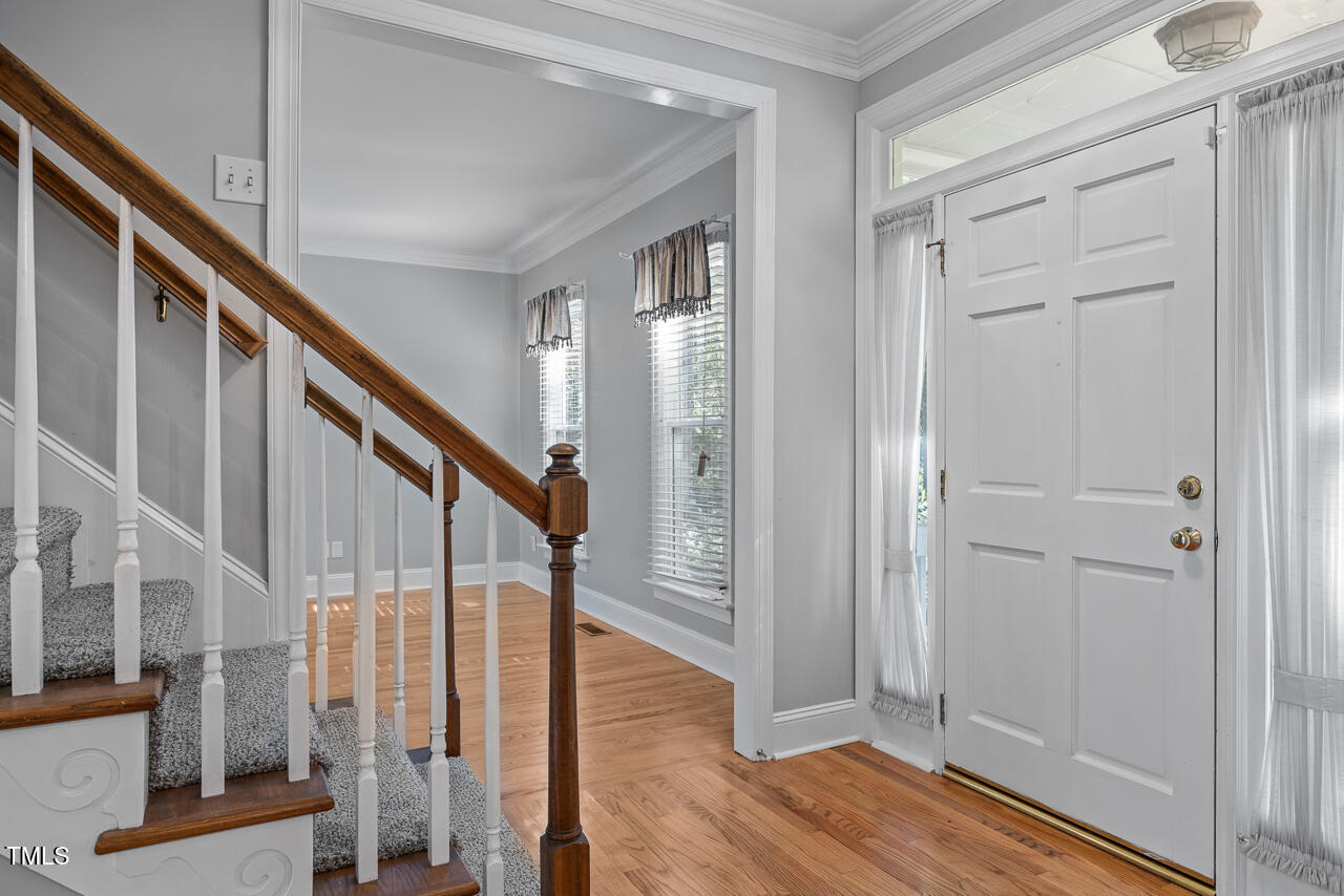 6229 Hampton Ridge Road Raleigh, NC 27603 - Photo 4 of 41 a view of an entryway with wooden floor and door