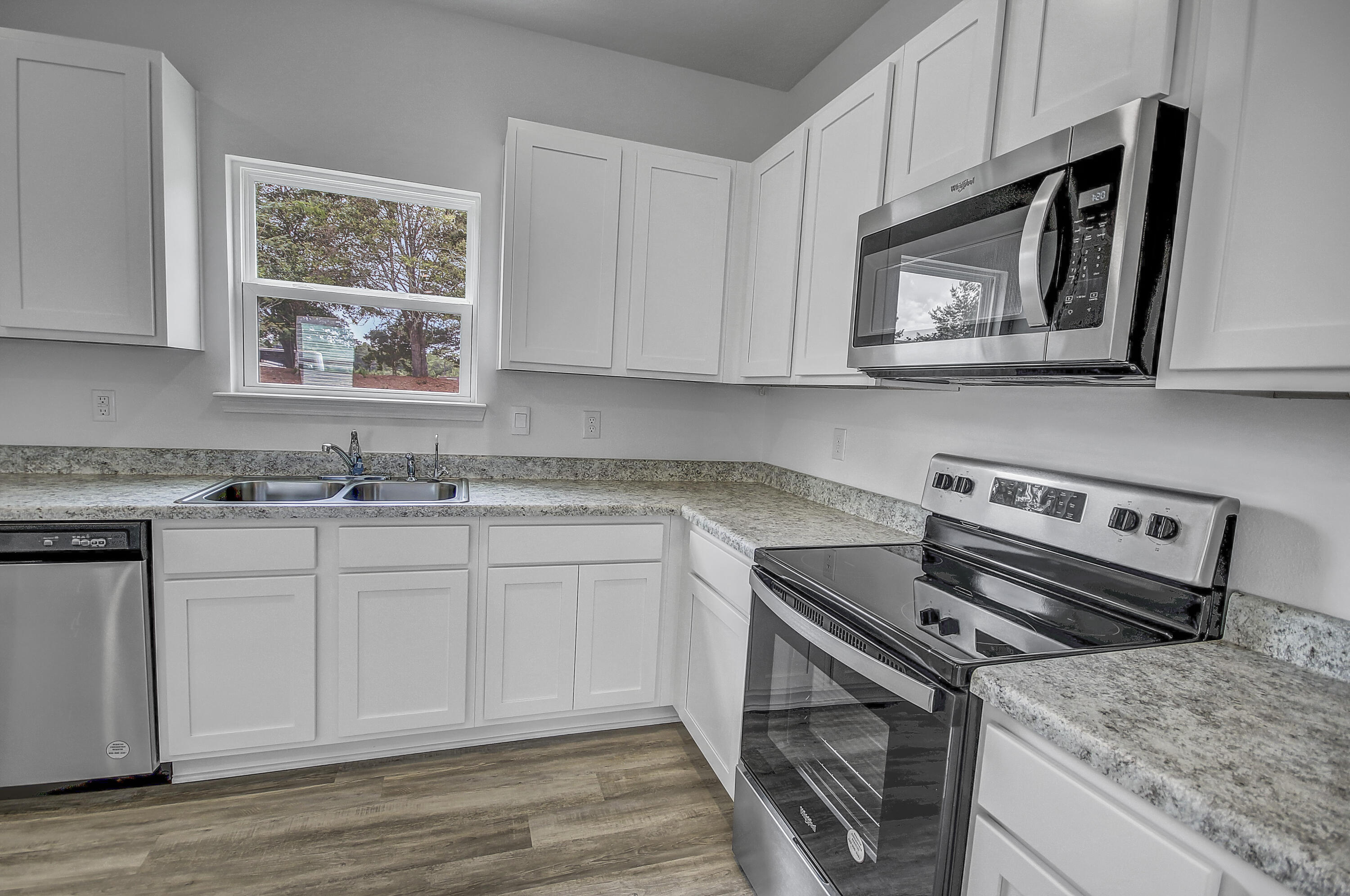 247 Staggerbush Street Freeport, FL 32439 - Photo 11 of 36 a kitchen with a stove microwave and sink