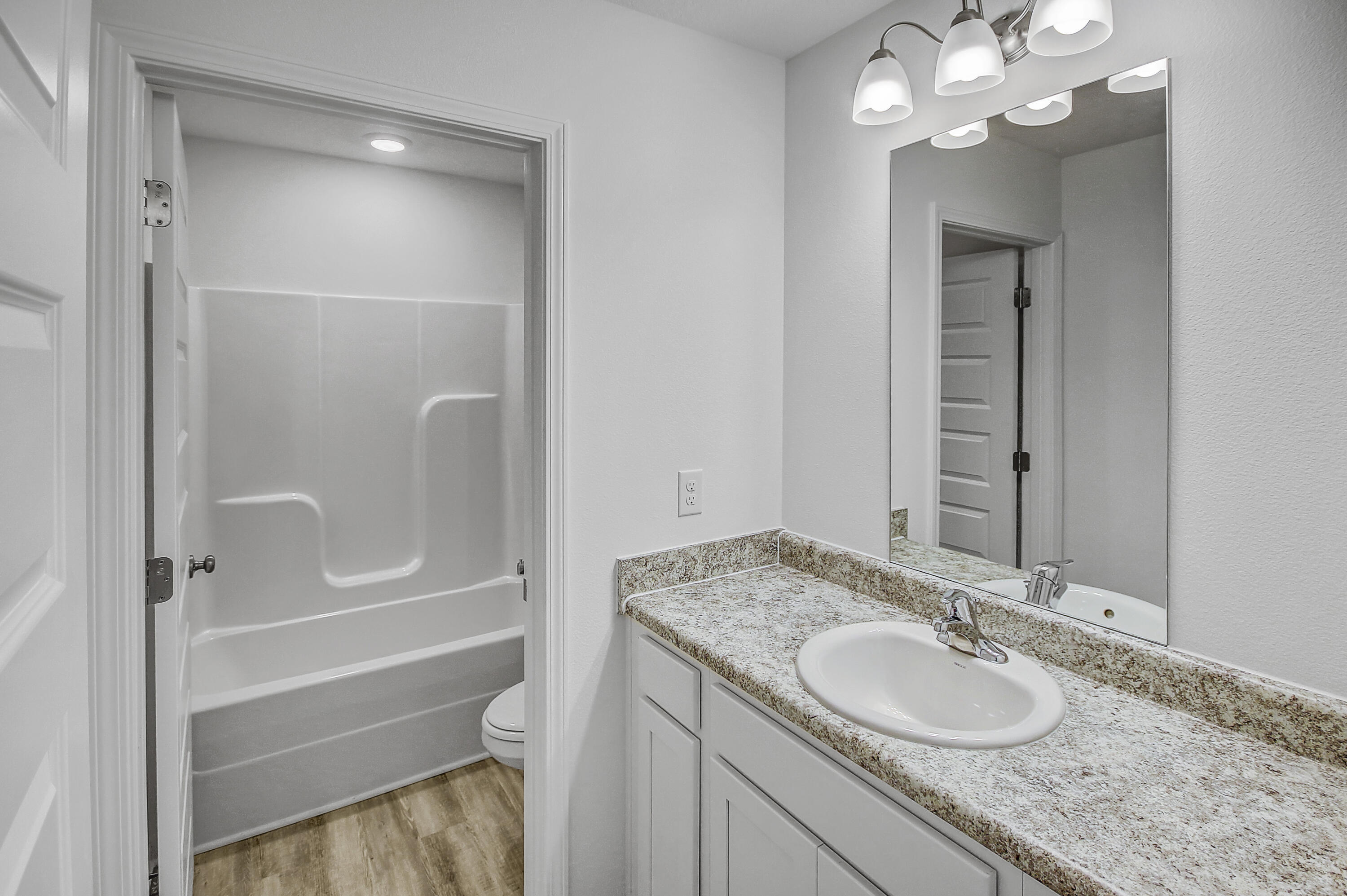 247 Staggerbush Street Freeport, FL 32439 - Photo 22 of 36 a bathroom with a granite countertop sink toilet and shower