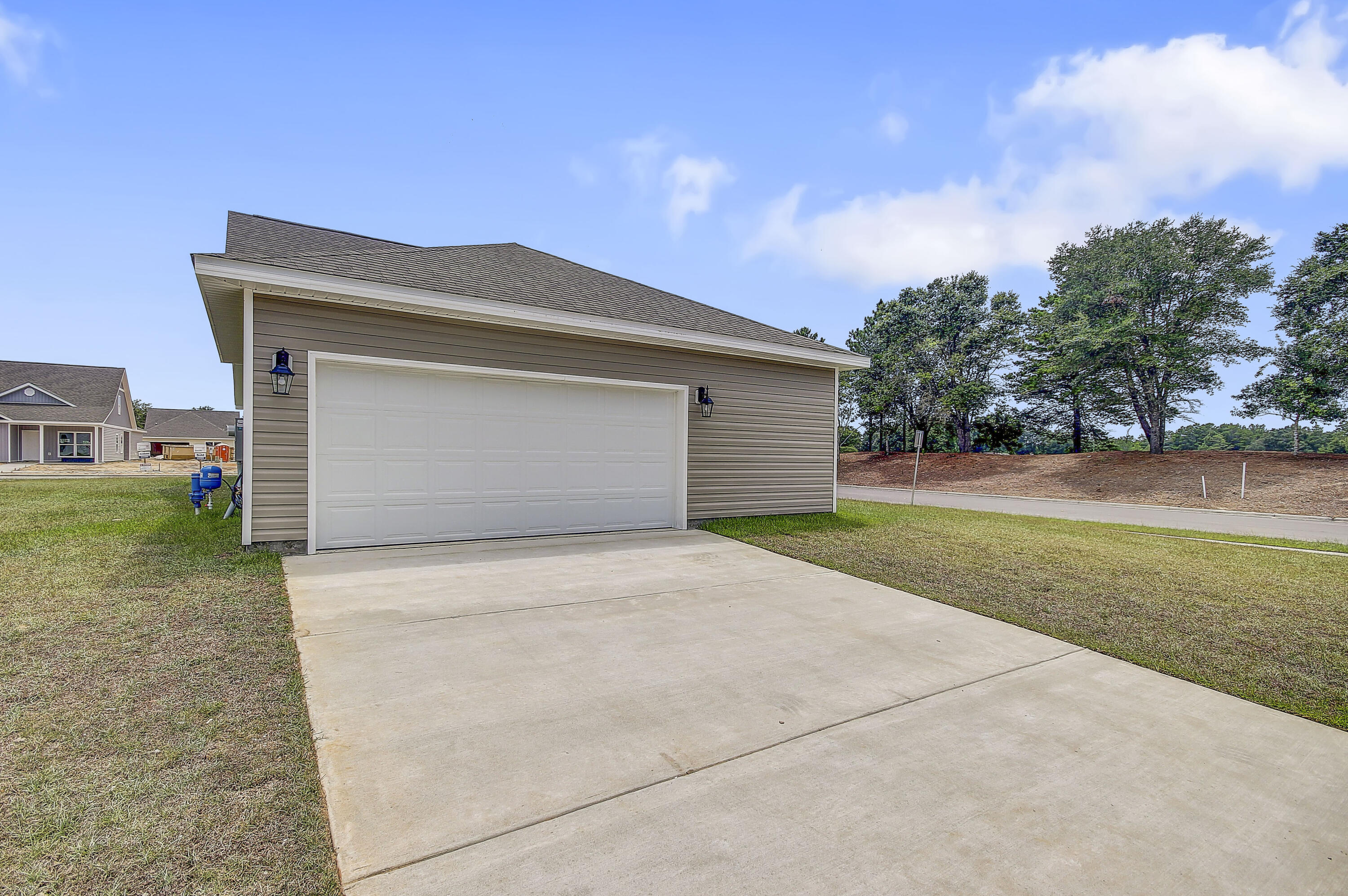 247 Staggerbush Street Freeport, FL 32439 - Photo 32 of 36 a front view of a house with a yard and garage