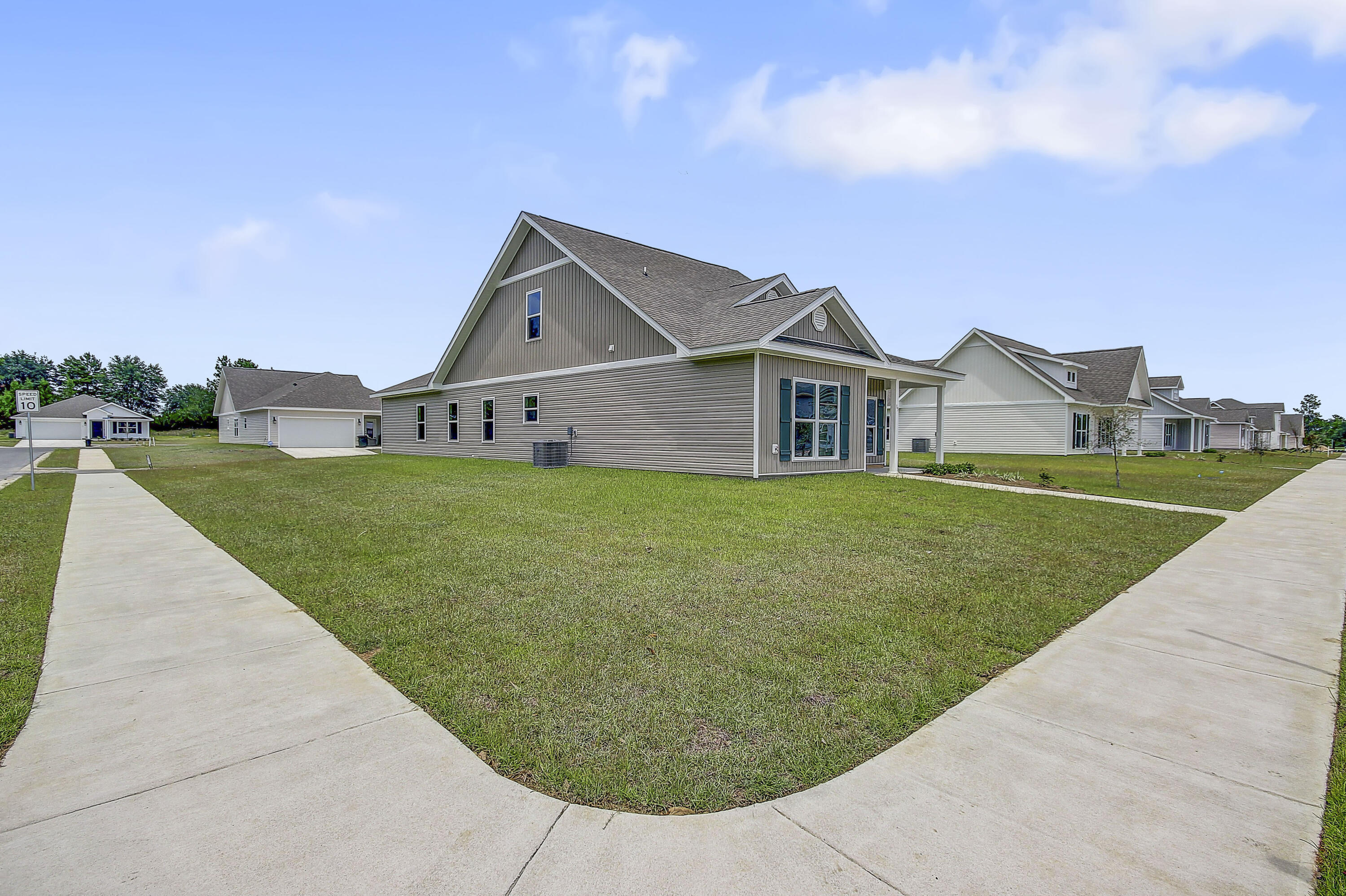 247 Staggerbush Street Freeport, FL 32439 - Photo 34 of 36 a view of a house with a big yard and large trees
