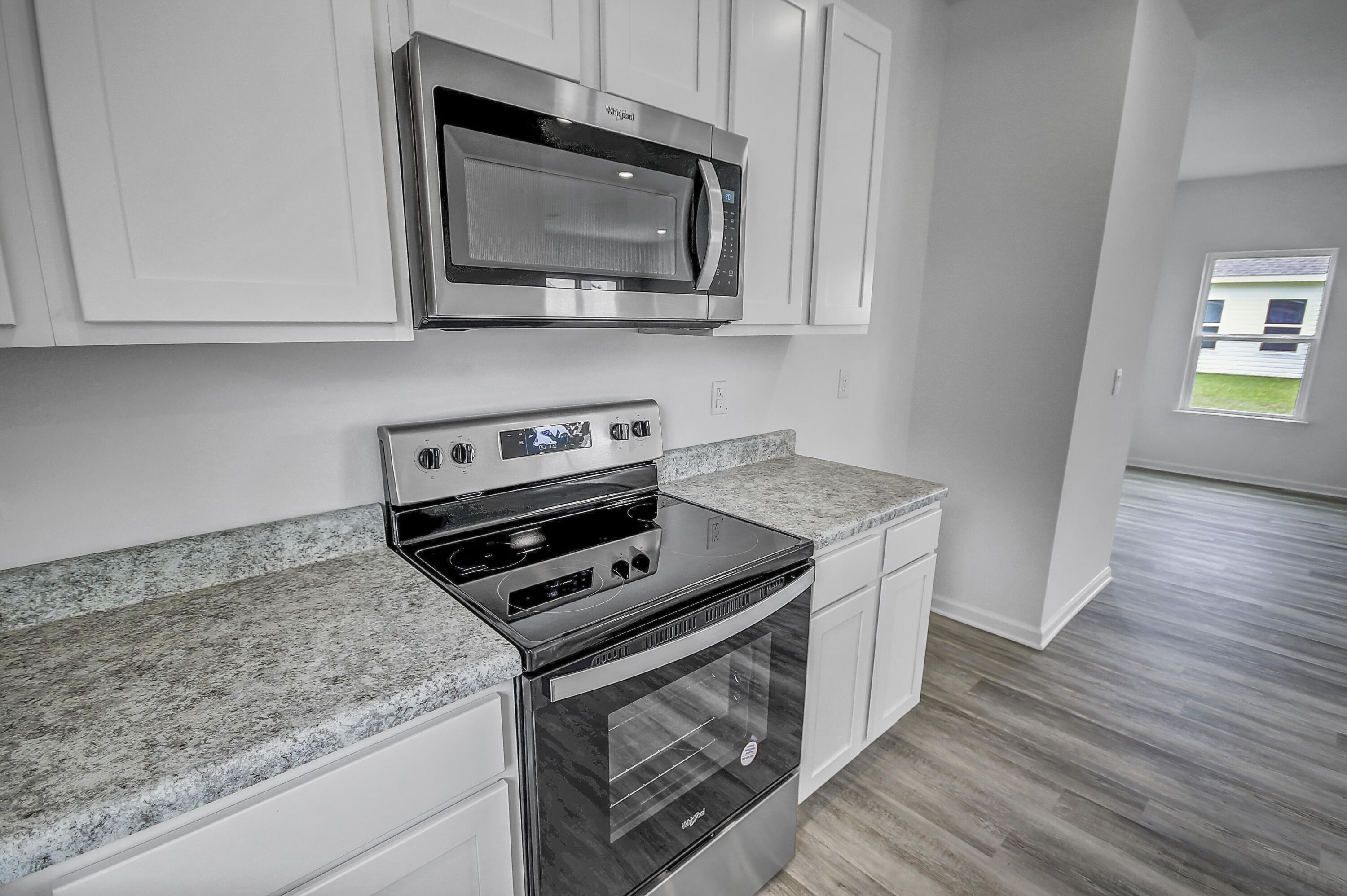 247 Staggerbush Street Freeport, FL 32439 - Photo 10 of 36 a kitchen with stainless steel appliances granite countertop a stove and a microwave