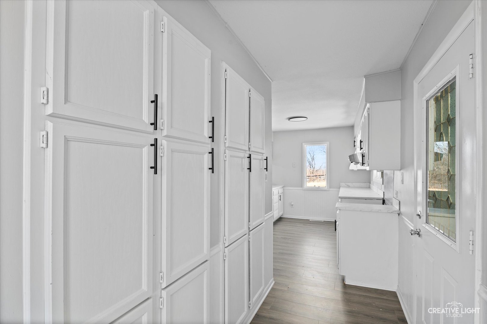 2391 North 24th Road Marseilles, IL 61341 - Photo 6 of 24 a view of a bedroom with wooden floor white walls and windows