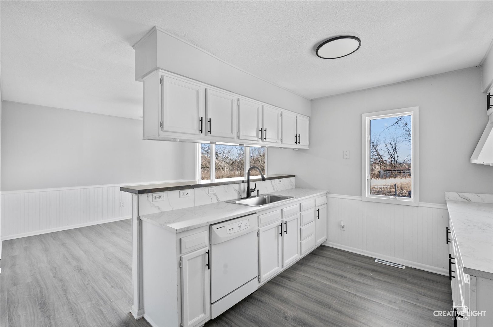 2391 North 24th Road Marseilles, IL 61341 - Photo 7 of 24 a kitchen with a sink cabinets and wooden floor