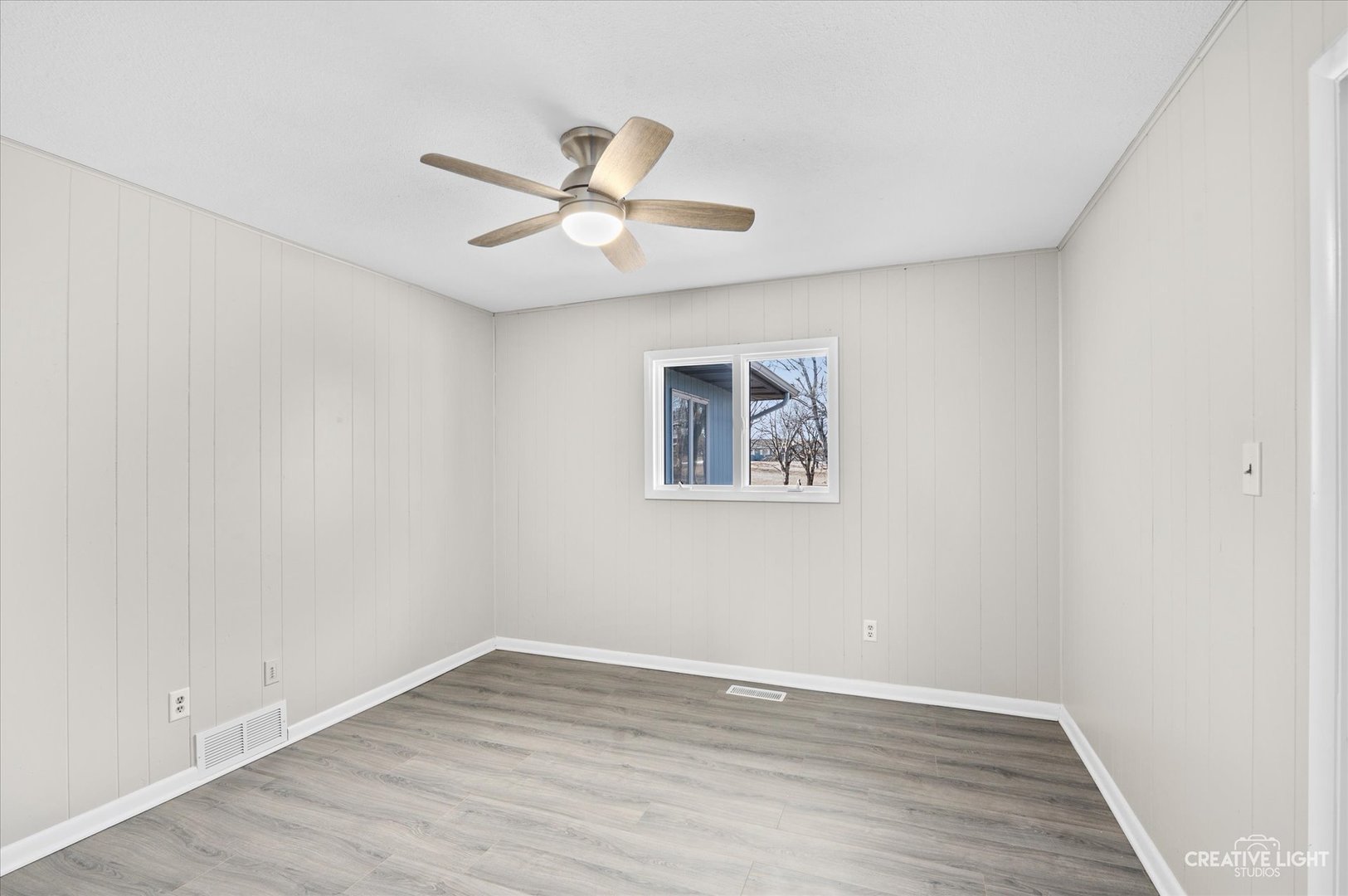 2391 North 24th Road Marseilles, IL 61341 - Photo 10 of 24 an empty room with wooden floor fan and windows