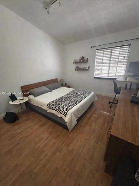 14212 Southwest 121st Place, Unit 6 Miami, FL 33186 - Photo 13 of 19 a bedroom with a bed and window