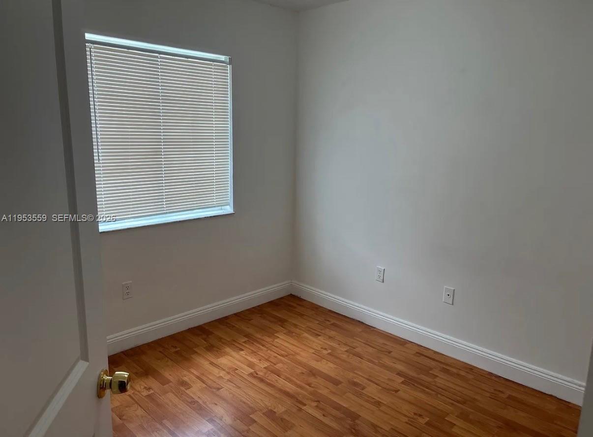 14212 Southwest 121st Place, Unit 6 Miami, FL 33186 - Photo 15 of 19 an empty room with a window