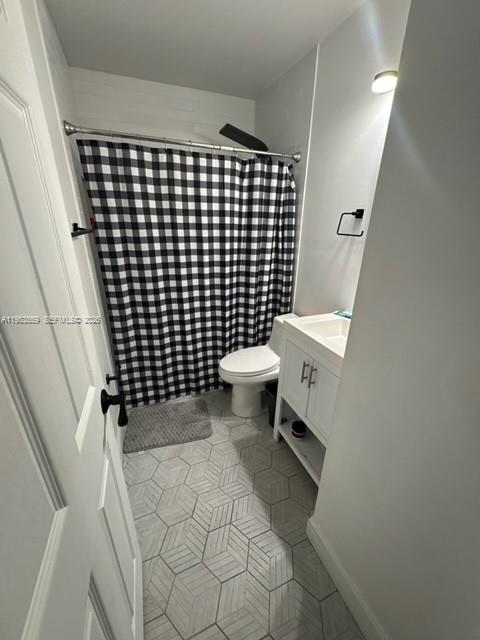 14212 Southwest 121st Place, Unit 6 Miami, FL 33186 - Photo 17 of 19 a bathroom with a sink and a toilet