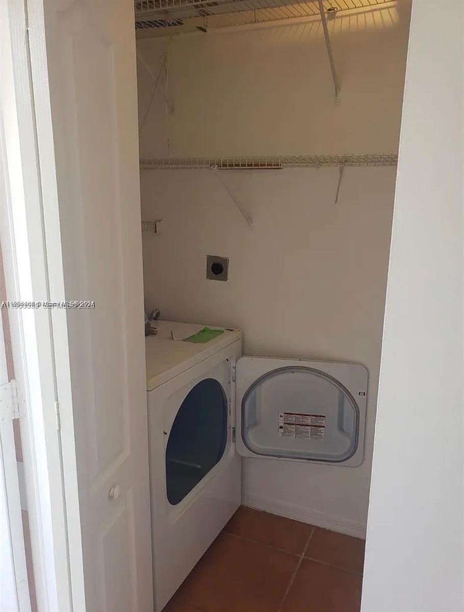 14212 Southwest 121st Place, Unit 6 Miami, FL 33186 - Photo 18 of 19 a utility room with dryer and washer