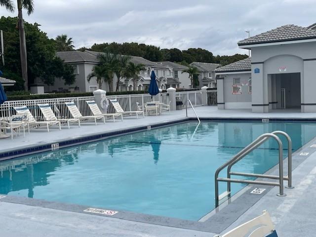 14212 Southwest 121st Place, Unit 6 Miami, FL 33186 - Photo 5 of 19 a view of a swimming pool with a lounge chairs