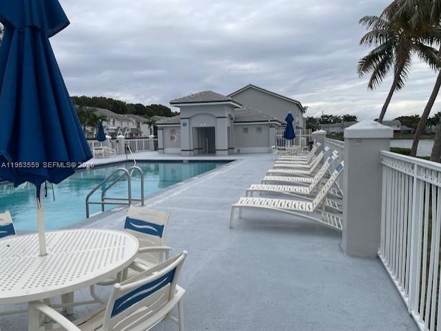 14212 Southwest 121st Place, Unit 6 Miami, FL 33186 - Photo 7 of 19 a view of a patio with a table and chairs