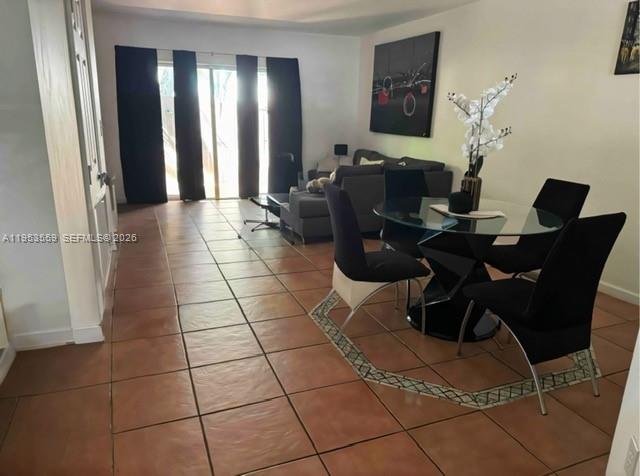 14212 Southwest 121st Place, Unit 6 Miami, FL 33186 - Photo 9 of 19 a living room with furniture and a table