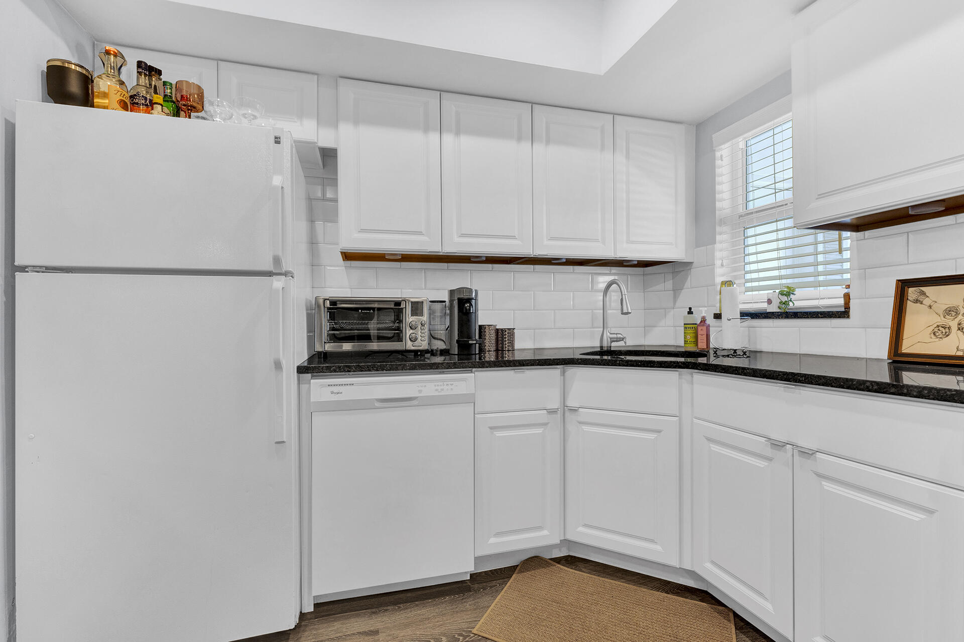 6100 Northeast 7th Avenue, Unit 20 Boca Raton, FL 33487 - Photo 12 of 42 a white refrigerator freezer sitting inside of a kitchen