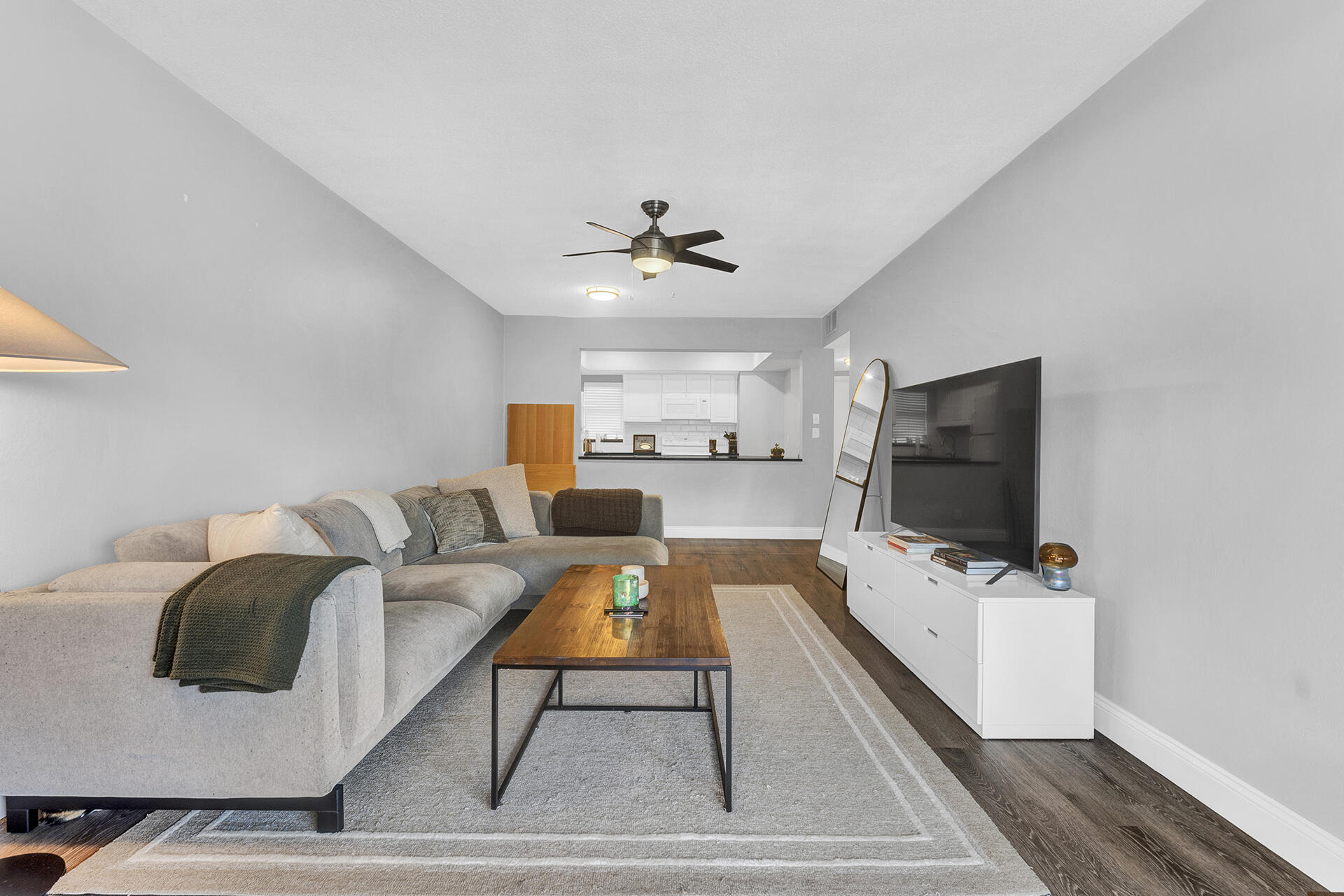 6100 Northeast 7th Avenue, Unit 20 Boca Raton, FL 33487 - Photo 13 of 42 a living room with furniture and a flat screen tv