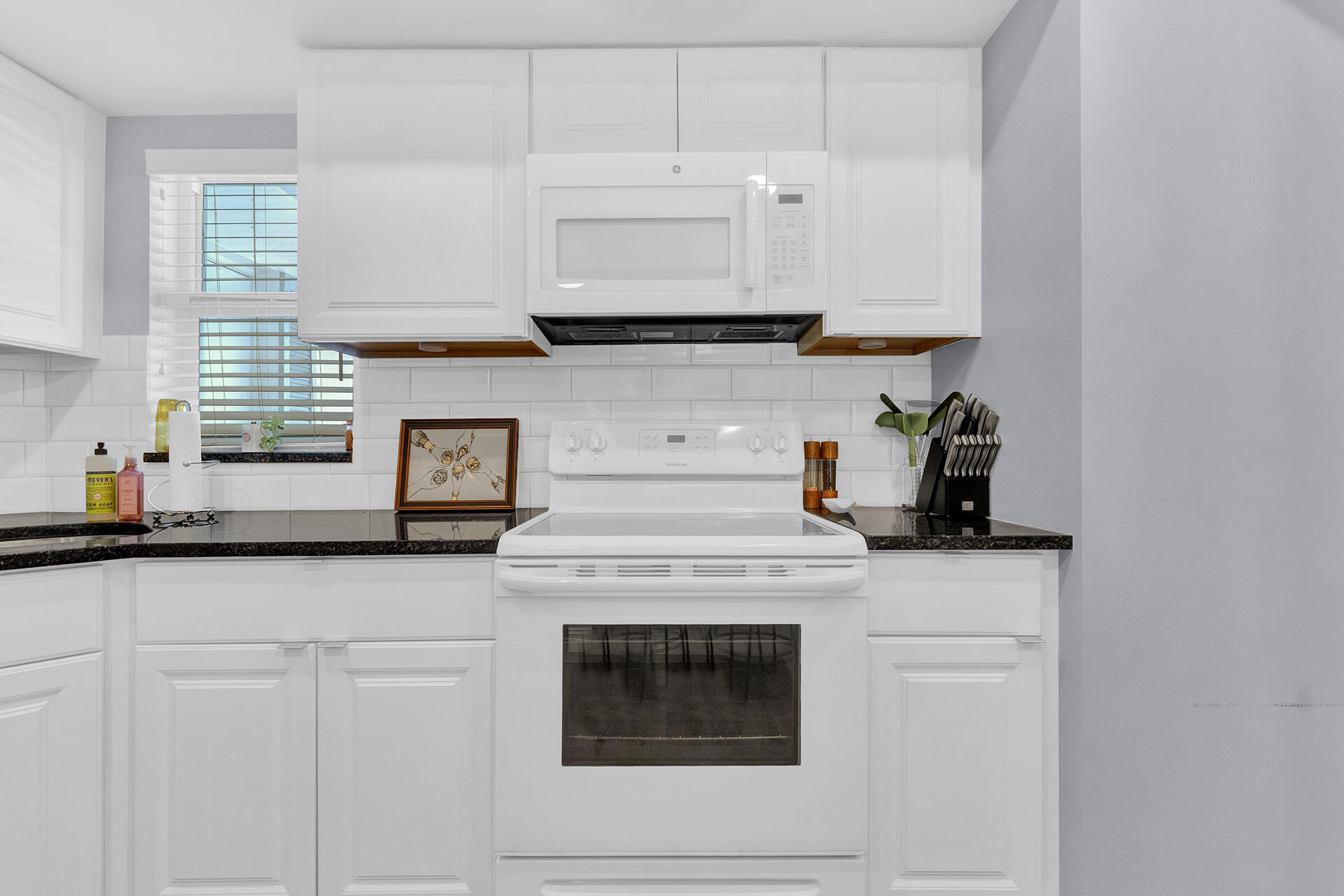 6100 Northeast 7th Avenue, Unit 20 Boca Raton, FL 33487 - Photo 14 of 42 a stove top oven sitting inside of a kitchen