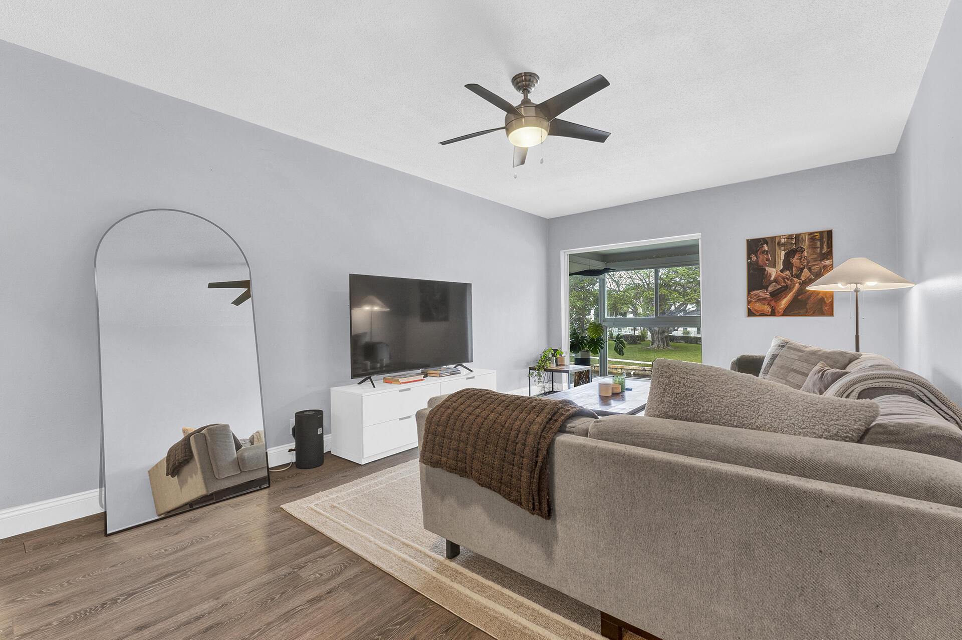 6100 Northeast 7th Avenue, Unit 20 Boca Raton, FL 33487 - Photo 15 of 42 a living room with furniture and a flat screen tv