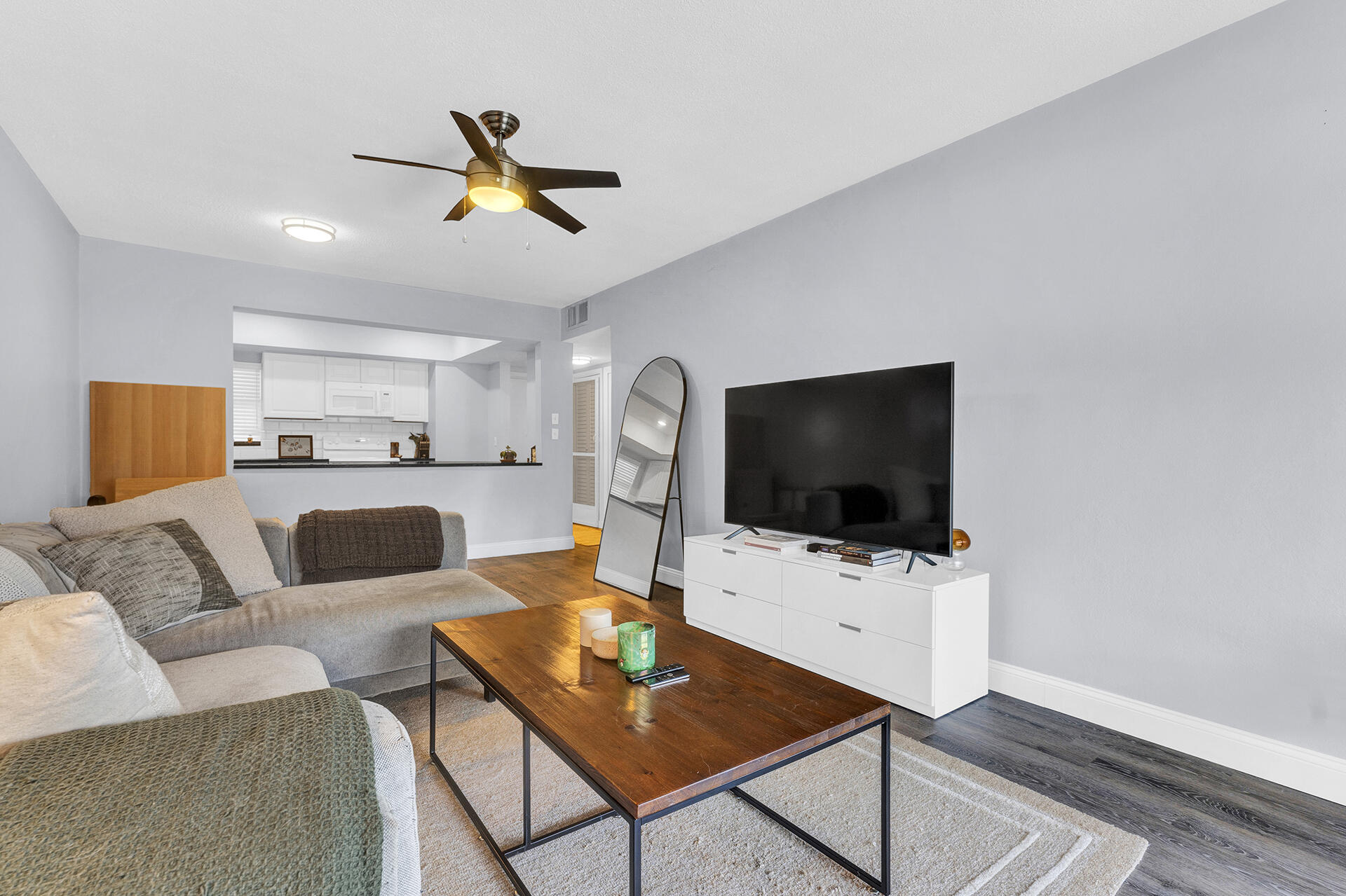 6100 Northeast 7th Avenue, Unit 20 Boca Raton, FL 33487 - Photo 16 of 42 a living room with furniture and a flat screen tv
