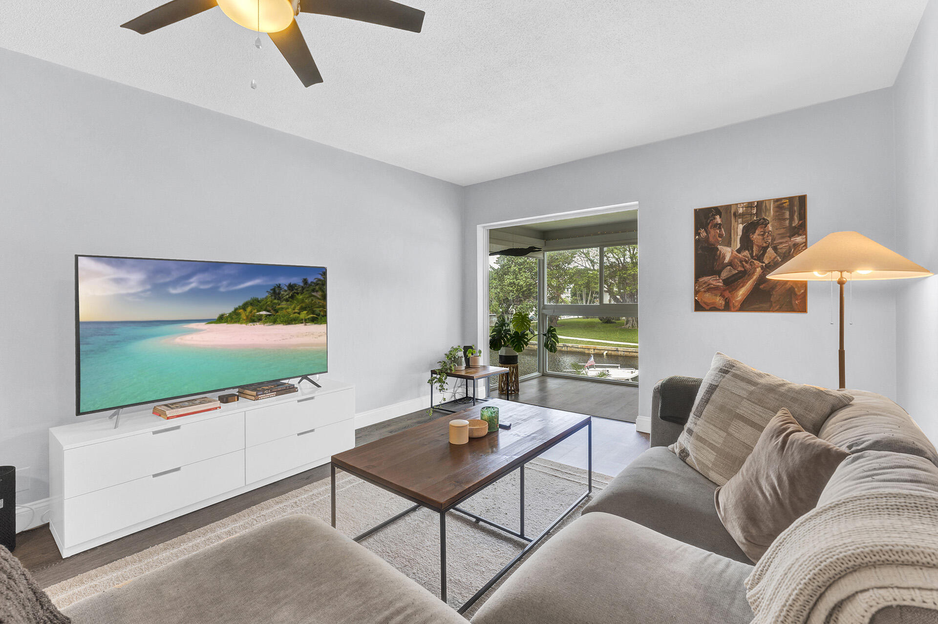 6100 Northeast 7th Avenue, Unit 20 Boca Raton, FL 33487 - Photo 2 of 42 a living room with furniture and a flat screen tv