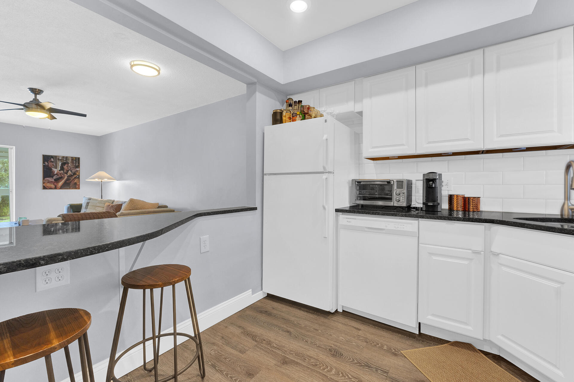6100 Northeast 7th Avenue, Unit 20 Boca Raton, FL 33487 - Photo 23 of 42 a kitchen with stainless steel appliances granite countertop a refrigerator and microwave