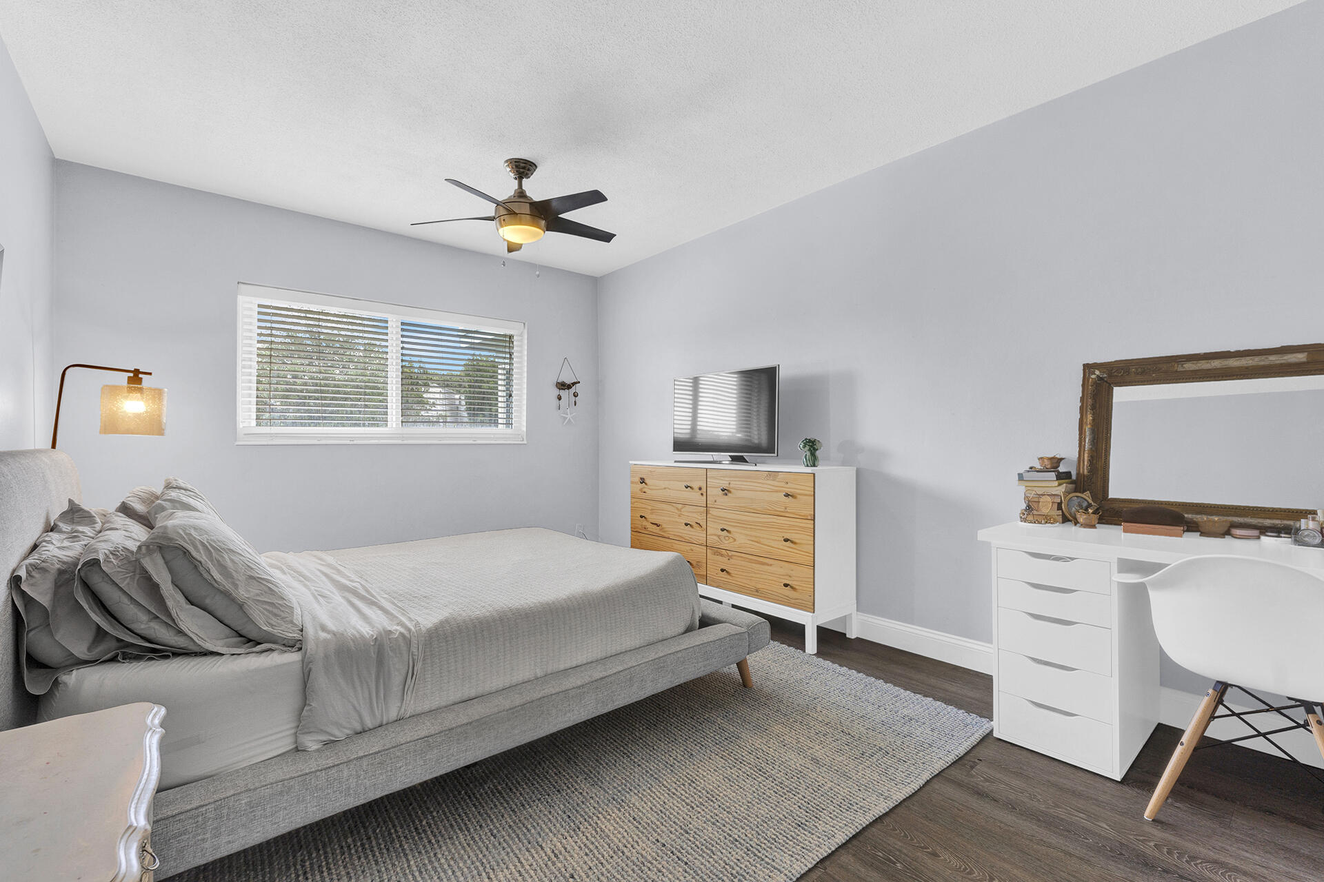 6100 Northeast 7th Avenue, Unit 20 Boca Raton, FL 33487 - Photo 26 of 42 a bedroom with a bed and a table in it