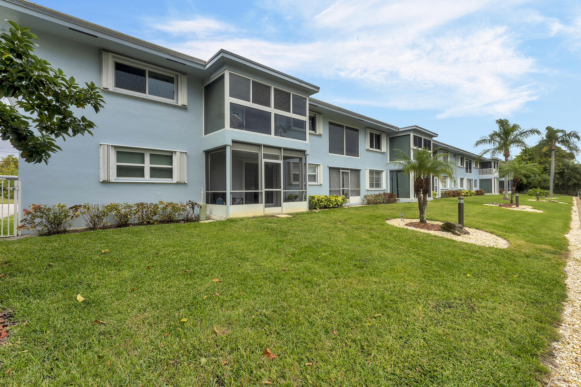 6100 Northeast 7th Avenue, Unit 20 Boca Raton, FL 33487 - Photo 3 of 42 a view of a house with a yard