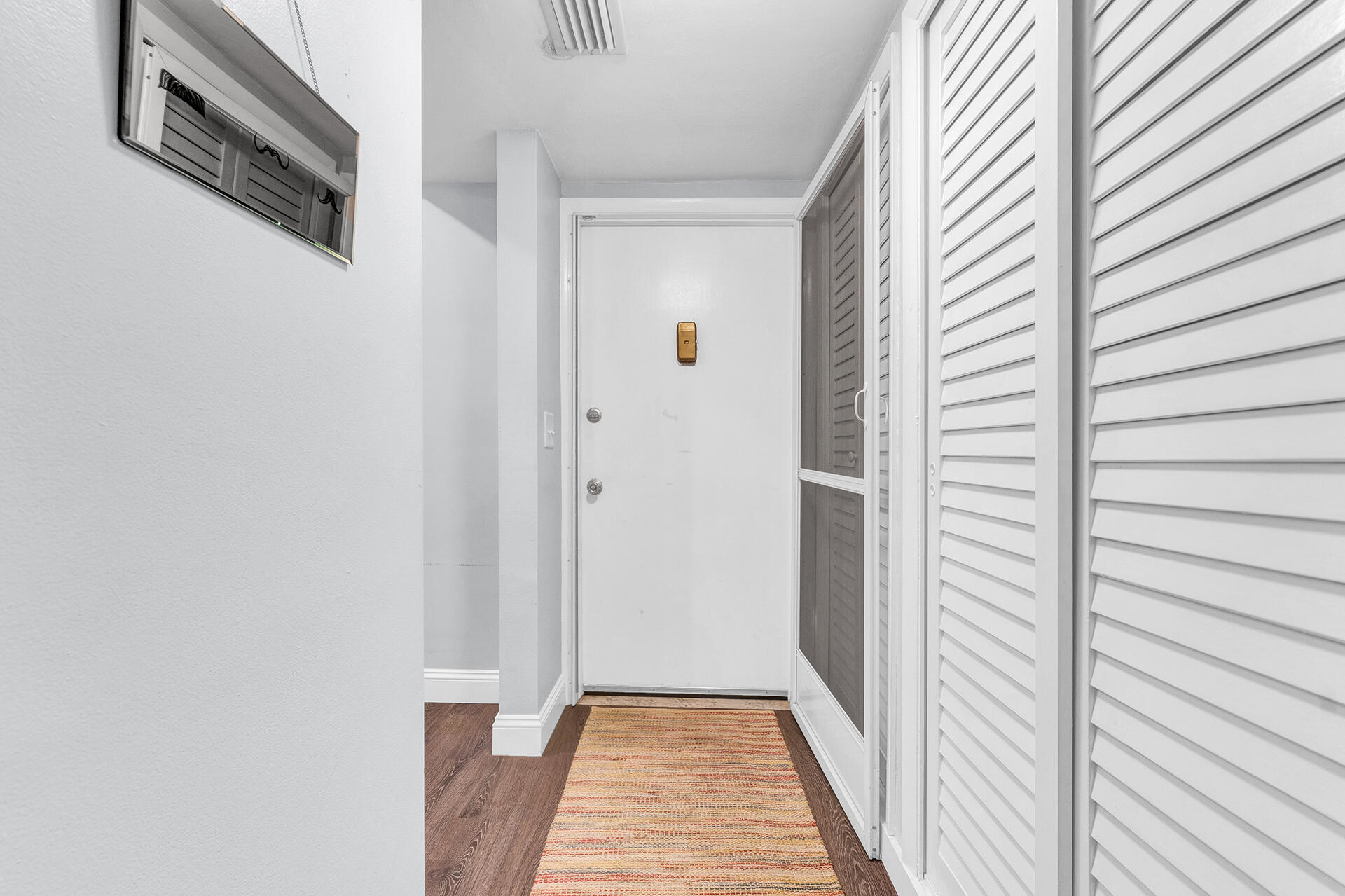 6100 Northeast 7th Avenue, Unit 20 Boca Raton, FL 33487 - Photo 33 of 42 a view of a hallway with wooden floor and staircase