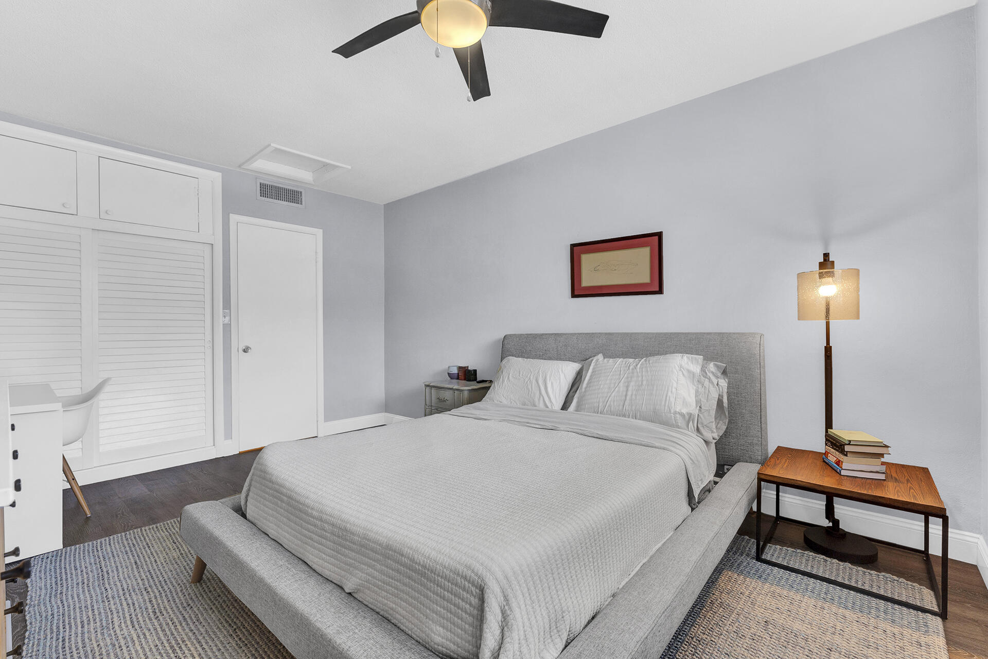6100 Northeast 7th Avenue, Unit 20 Boca Raton, FL 33487 - Photo 4 of 42 a spacious bedroom with a bed and a couch