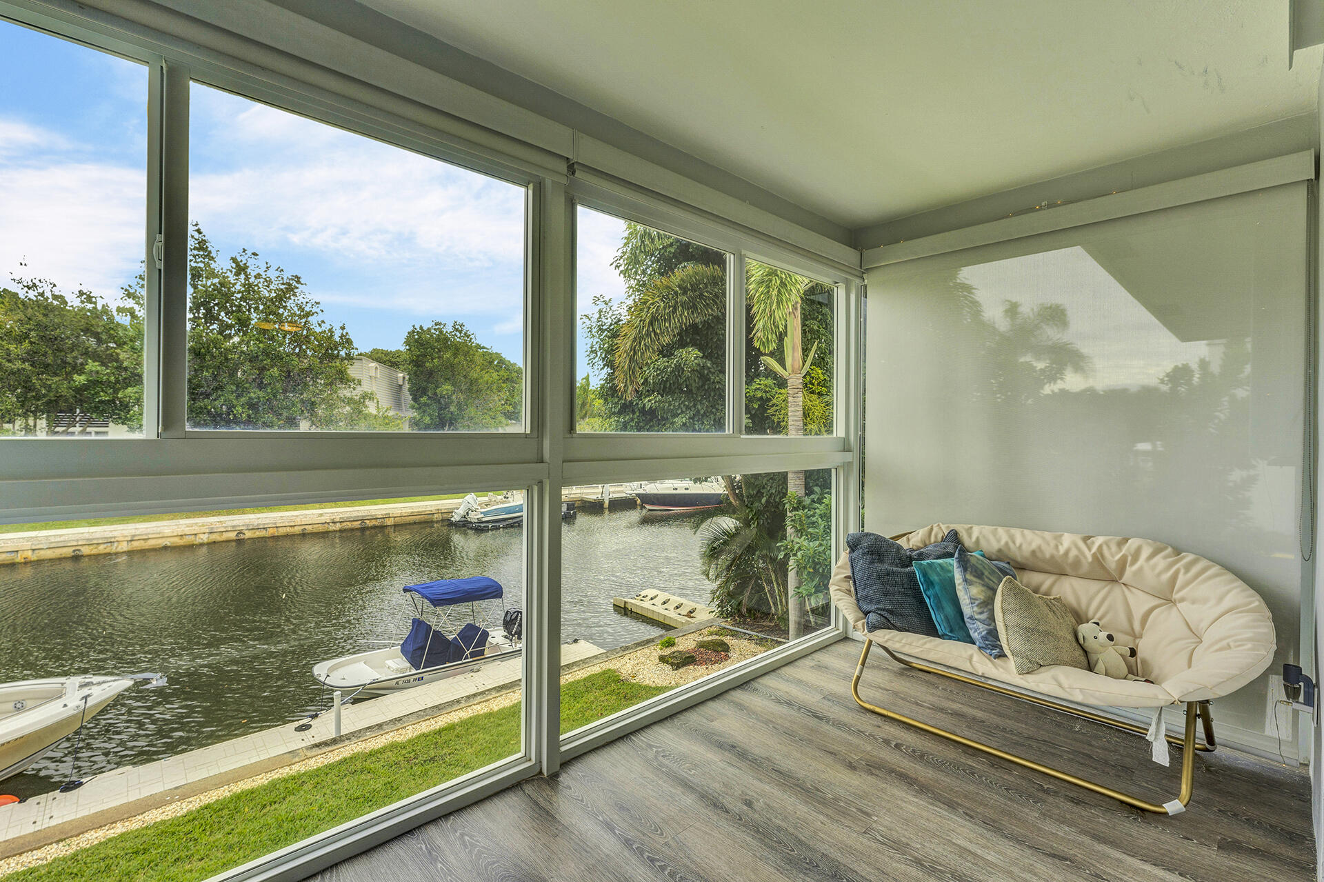 6100 Northeast 7th Avenue, Unit 20 Boca Raton, FL 33487 - Photo 5 of 42 a living room with a floor to ceiling window and a table