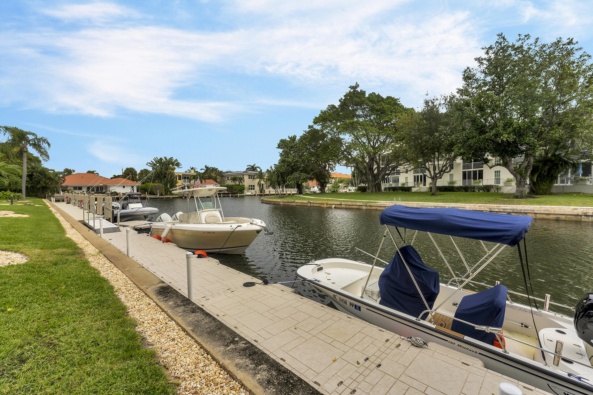 6100 Northeast 7th Avenue, Unit 20 Boca Raton, FL 33487 - Photo 6 of 42 a view of a lake with couches chairs and fire pit
