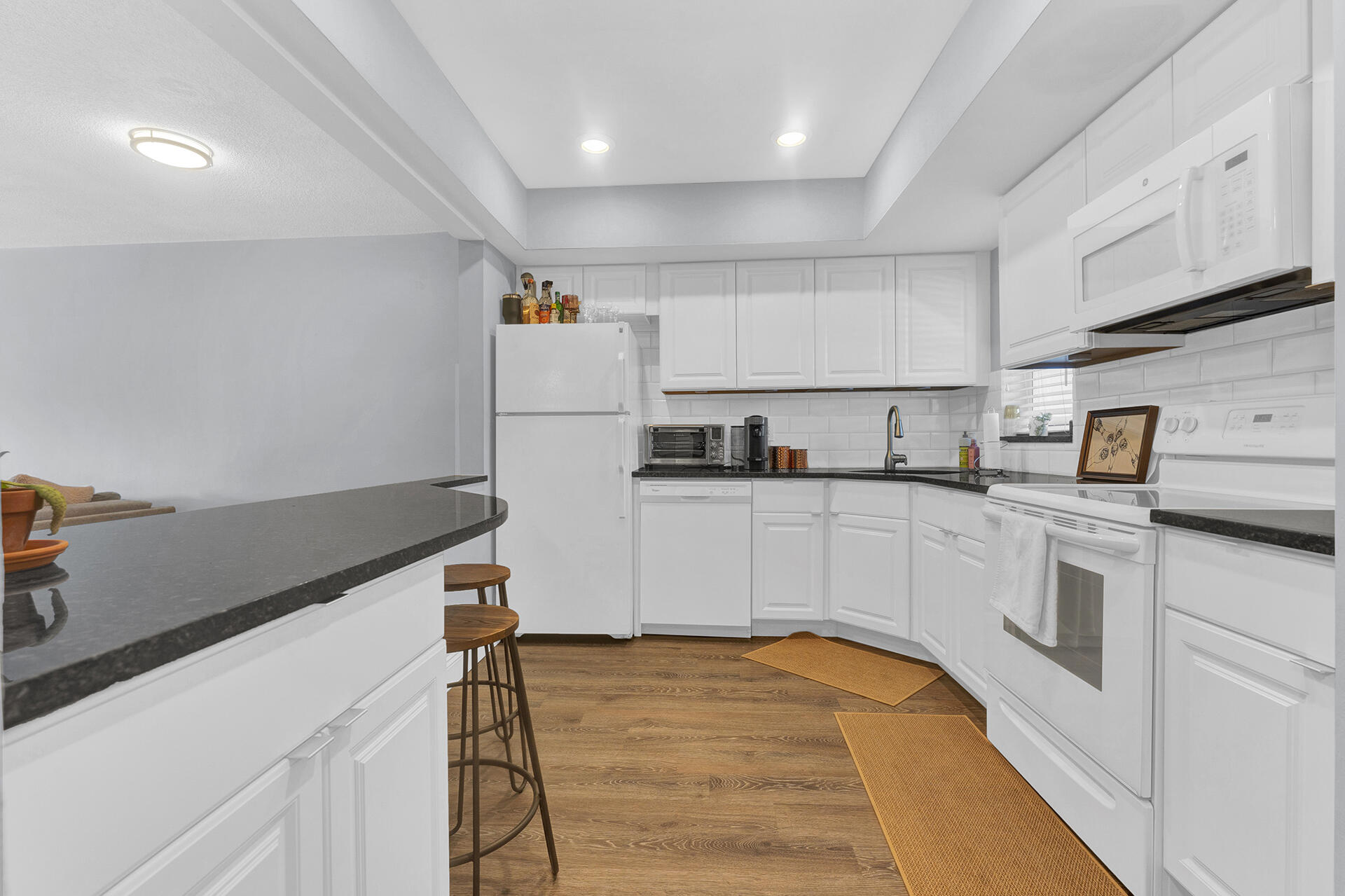 6100 Northeast 7th Avenue, Unit 20 Boca Raton, FL 33487 - Photo 7 of 42 a kitchen with a refrigerator and white cabinets