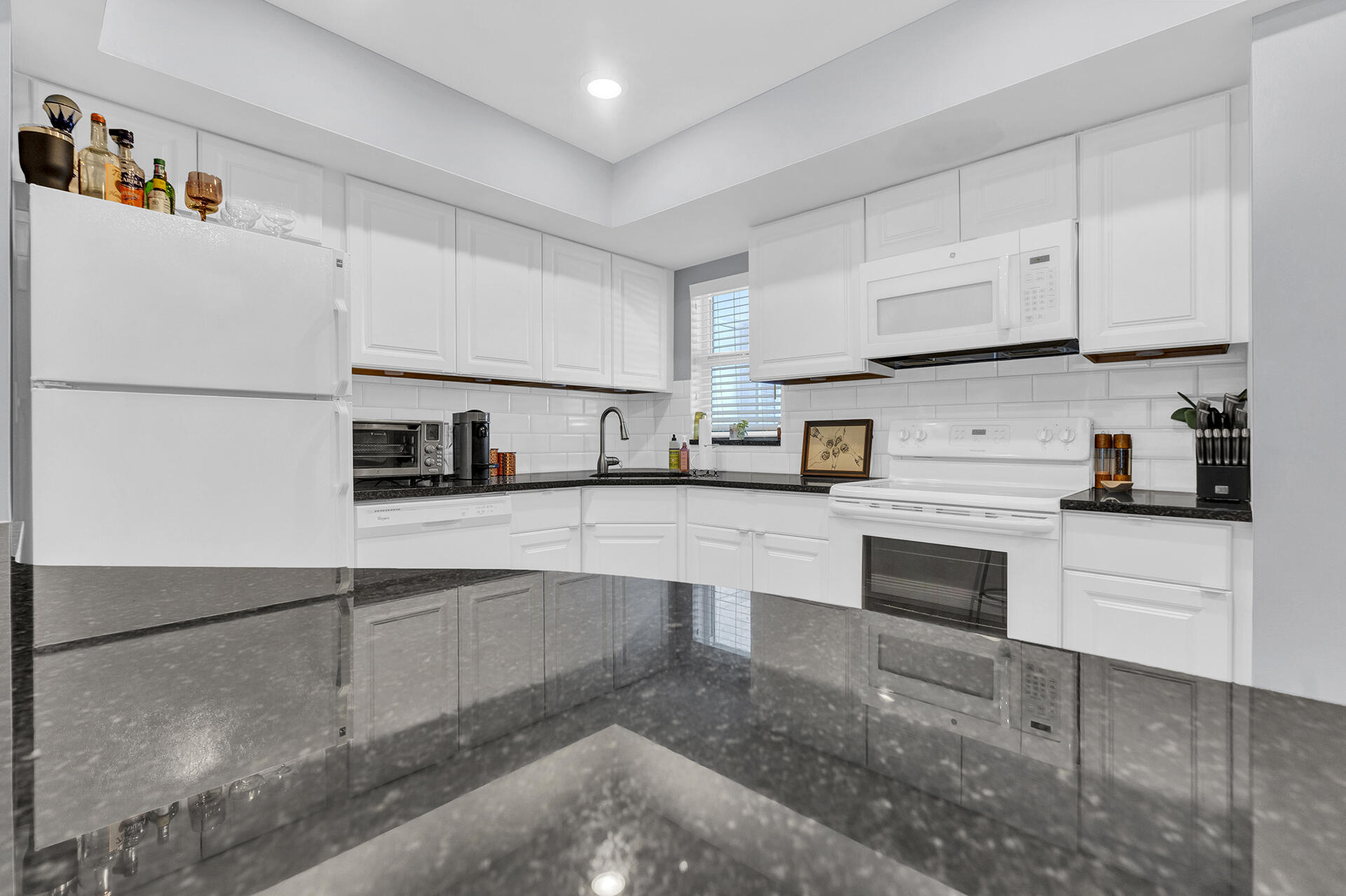 6100 Northeast 7th Avenue, Unit 20 Boca Raton, FL 33487 - Photo 9 of 42 a kitchen with kitchen island a white counter top space and cabinets
