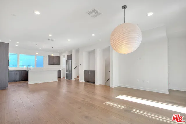 a view of a living room a kitchen and a chandelier