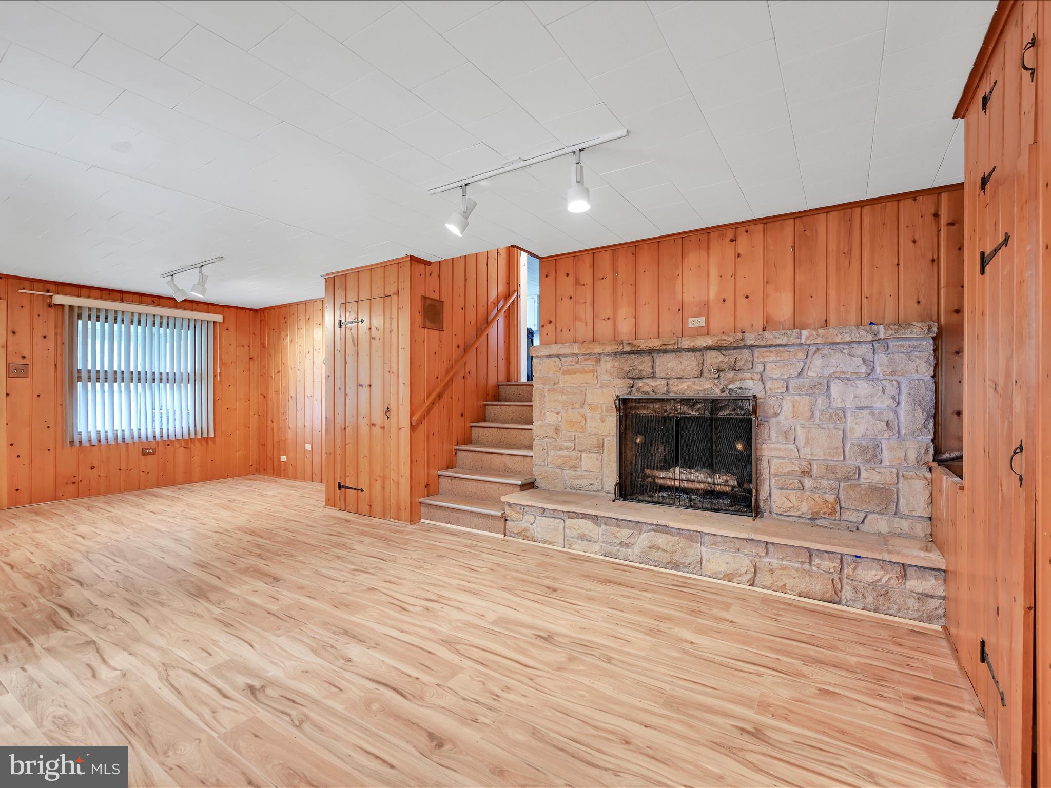 49 Sylvania Road Hershey, PA 17033 - Photo 14 of 29 an empty room with wooden floor fireplace and windows