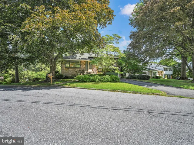 a view of house with yard and green space