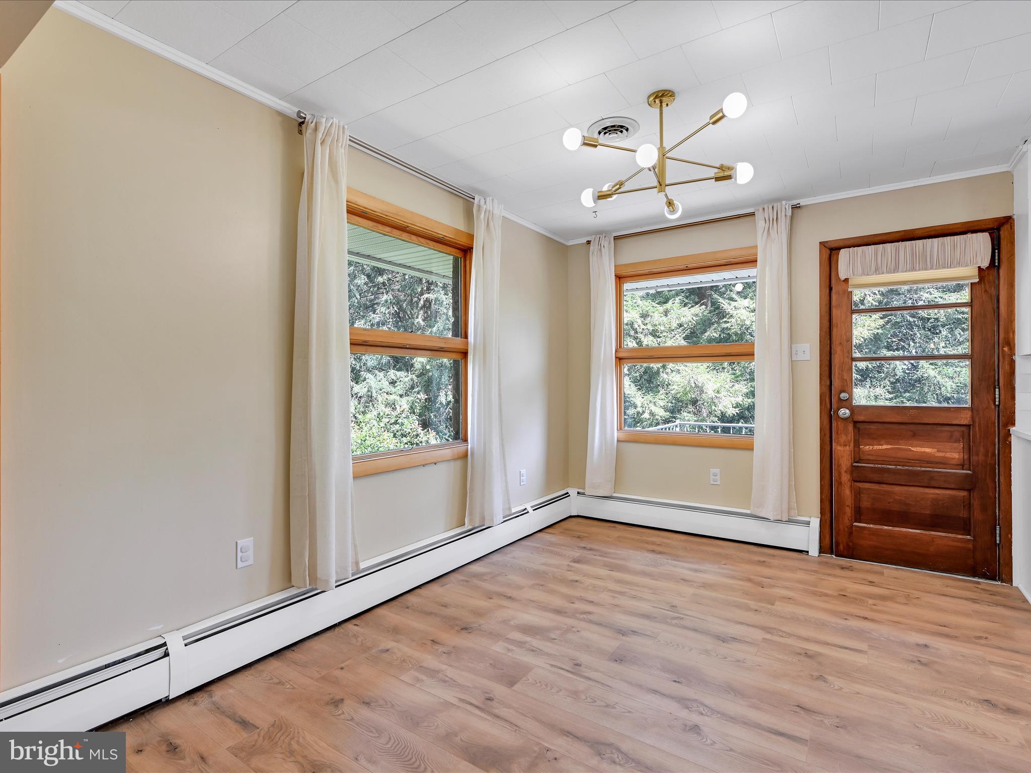 49 Sylvania Road Hershey, PA 17033 - Photo 7 of 29 a view of an empty room with a window and wooden floor