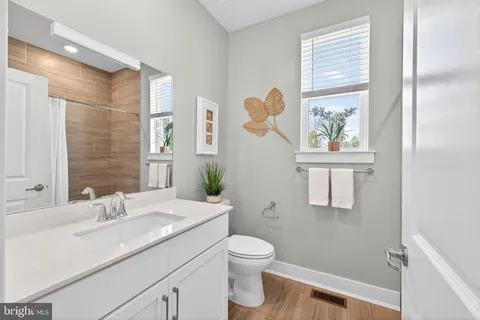 a spacious bathroom with a double vanity sink and a large mirror
