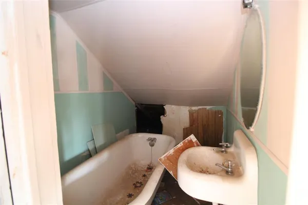 a bathroom with a bathtub and sink
