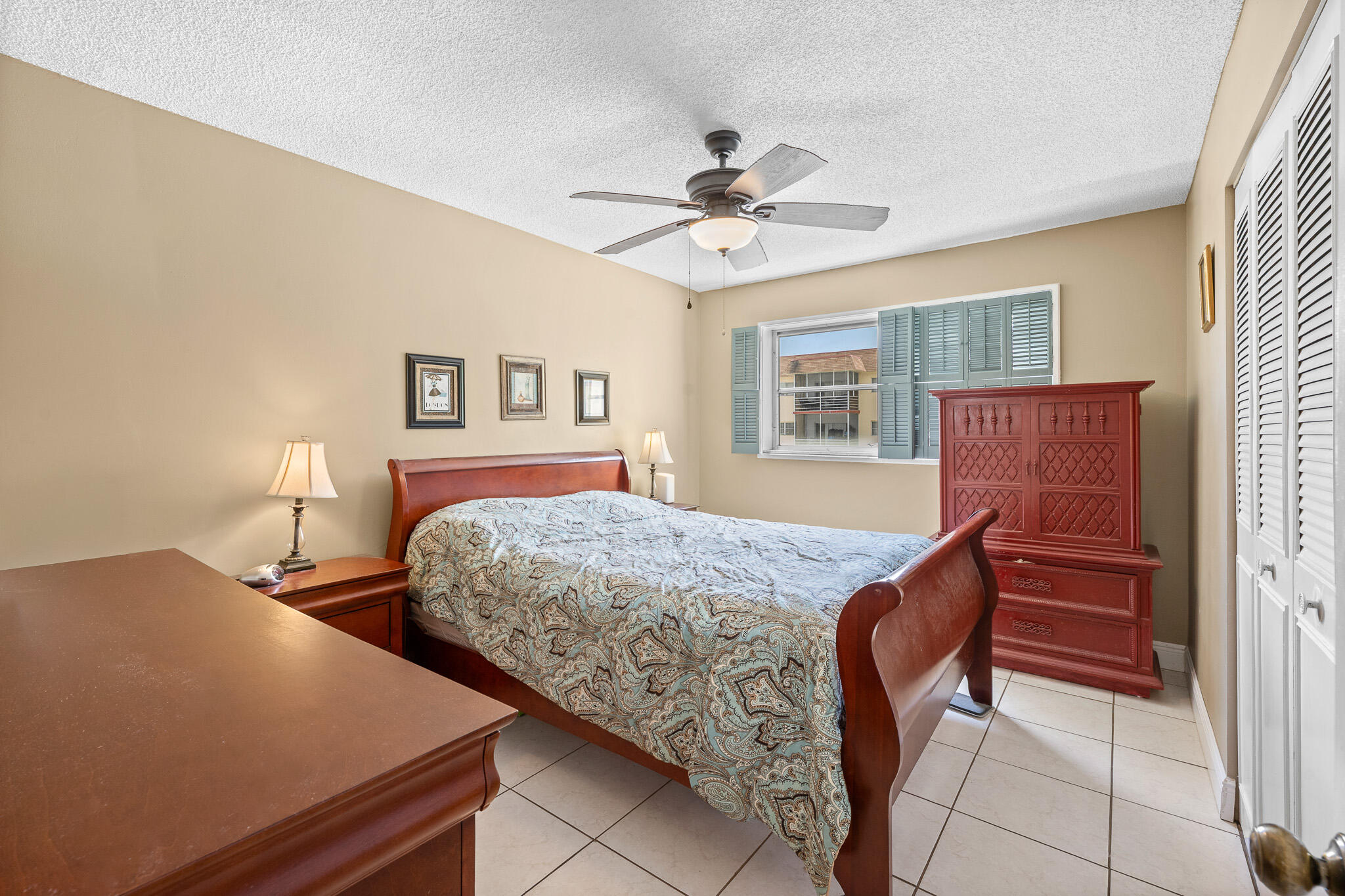 4047 Northwest 16th Street, Unit 206 Lauderhill, FL 33313 - Photo 14 of 26 a bedroom with a bed and a chandelier