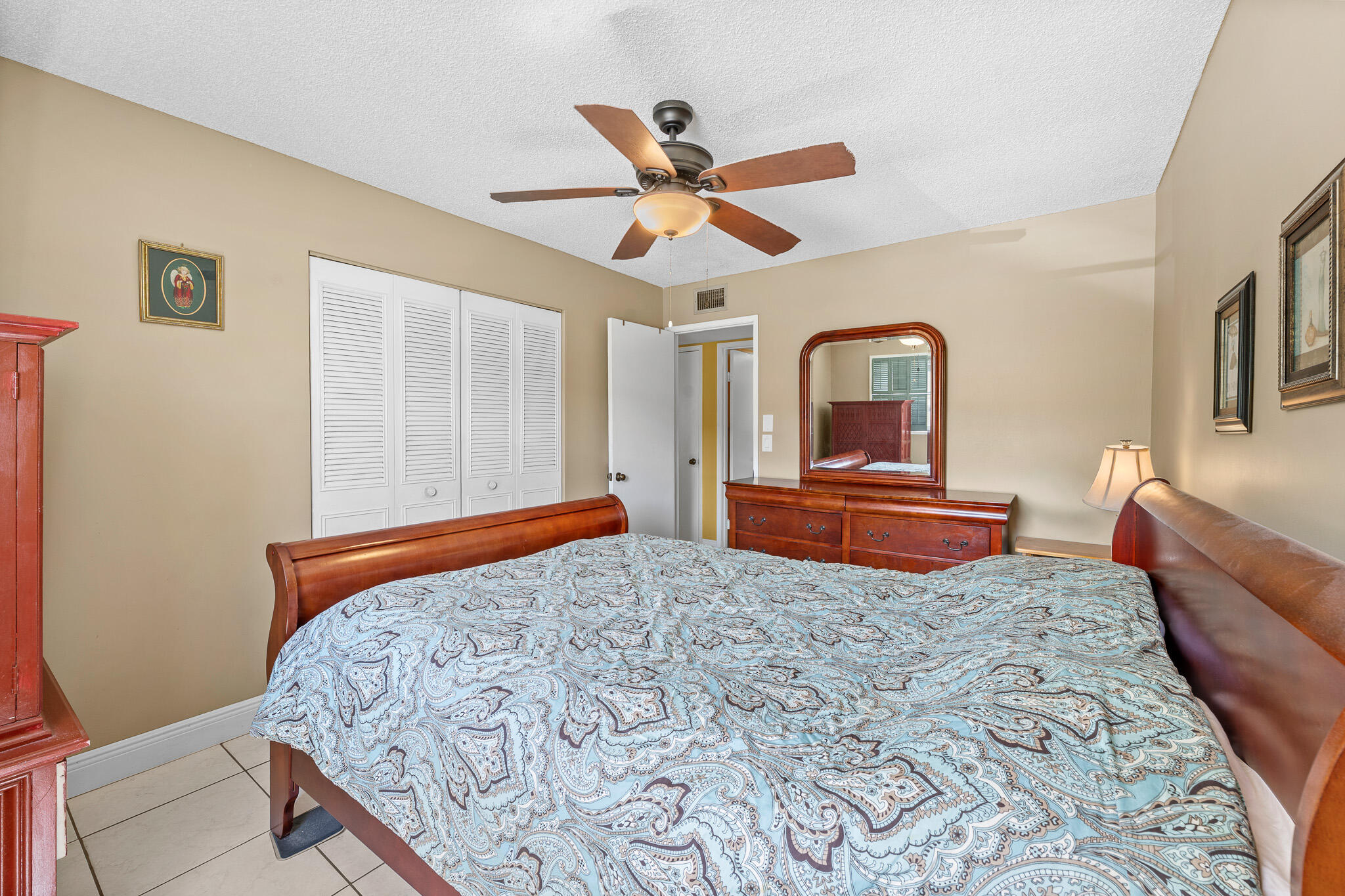 4047 Northwest 16th Street, Unit 206 Lauderhill, FL 33313 - Photo 15 of 26 a bedroom with a bed and a chandelier