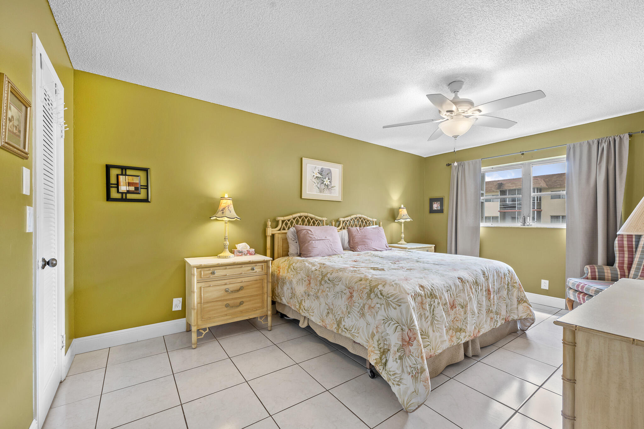 4047 Northwest 16th Street, Unit 206 Lauderhill, FL 33313 - Photo 17 of 26 a spacious bedroom with a bed and a table