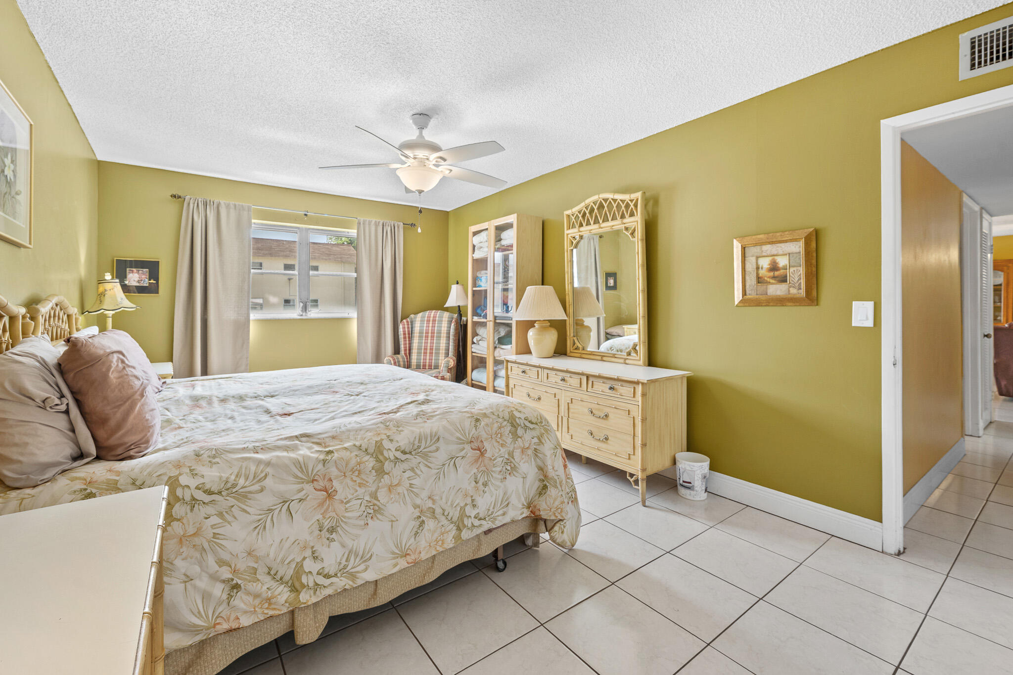 4047 Northwest 16th Street, Unit 206 Lauderhill, FL 33313 - Photo 18 of 26 a bed room with a bed and large windows