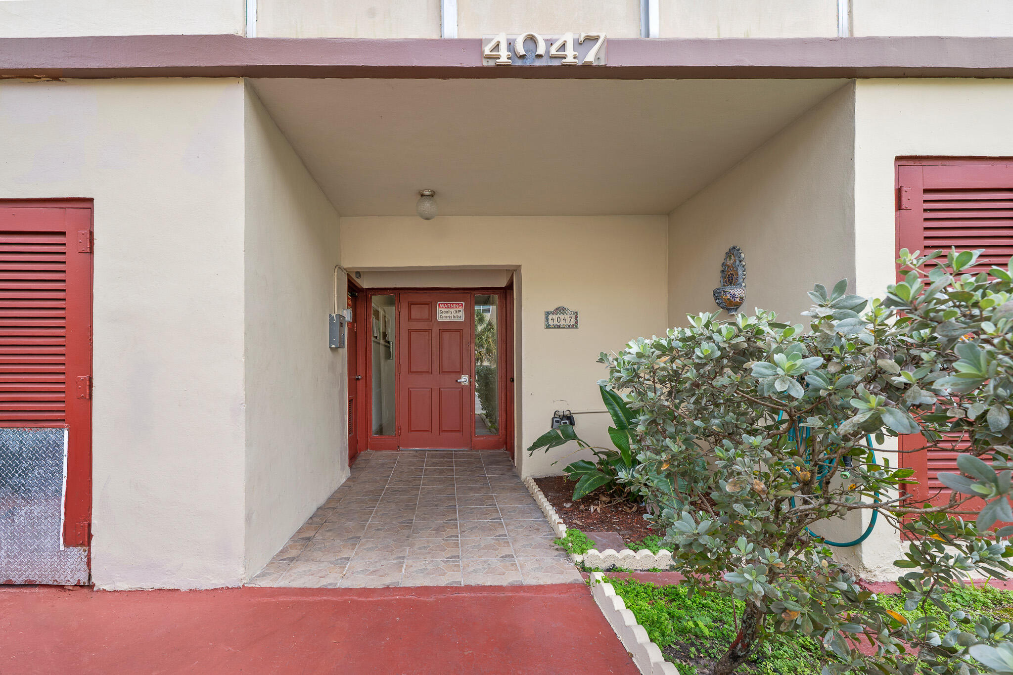 4047 Northwest 16th Street, Unit 206 Lauderhill, FL 33313 - Photo 2 of 26 a view of a house with a street