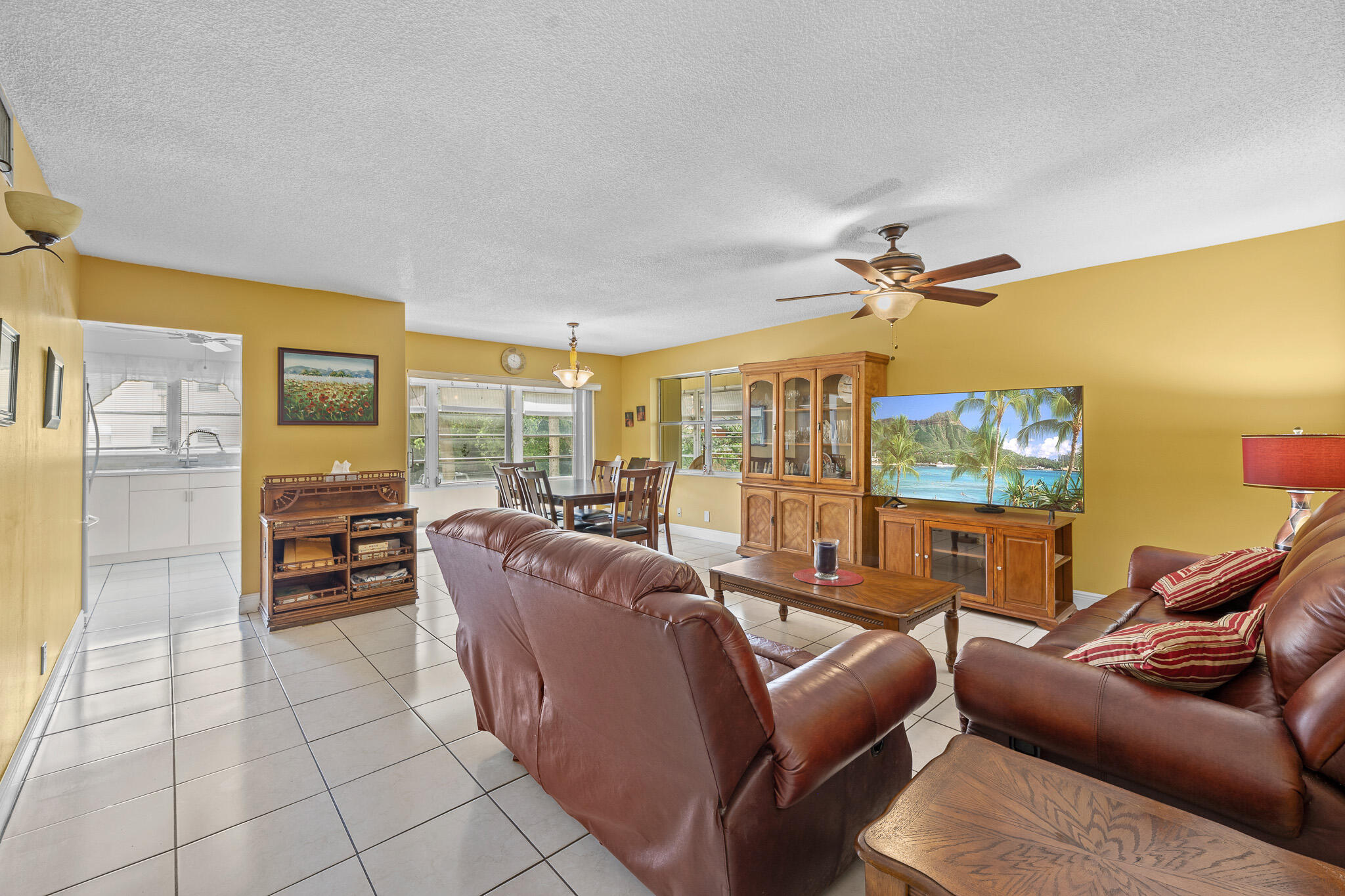4047 Northwest 16th Street, Unit 206 Lauderhill, FL 33313 - Photo 6 of 26 a living room with furniture and a flat screen tv
