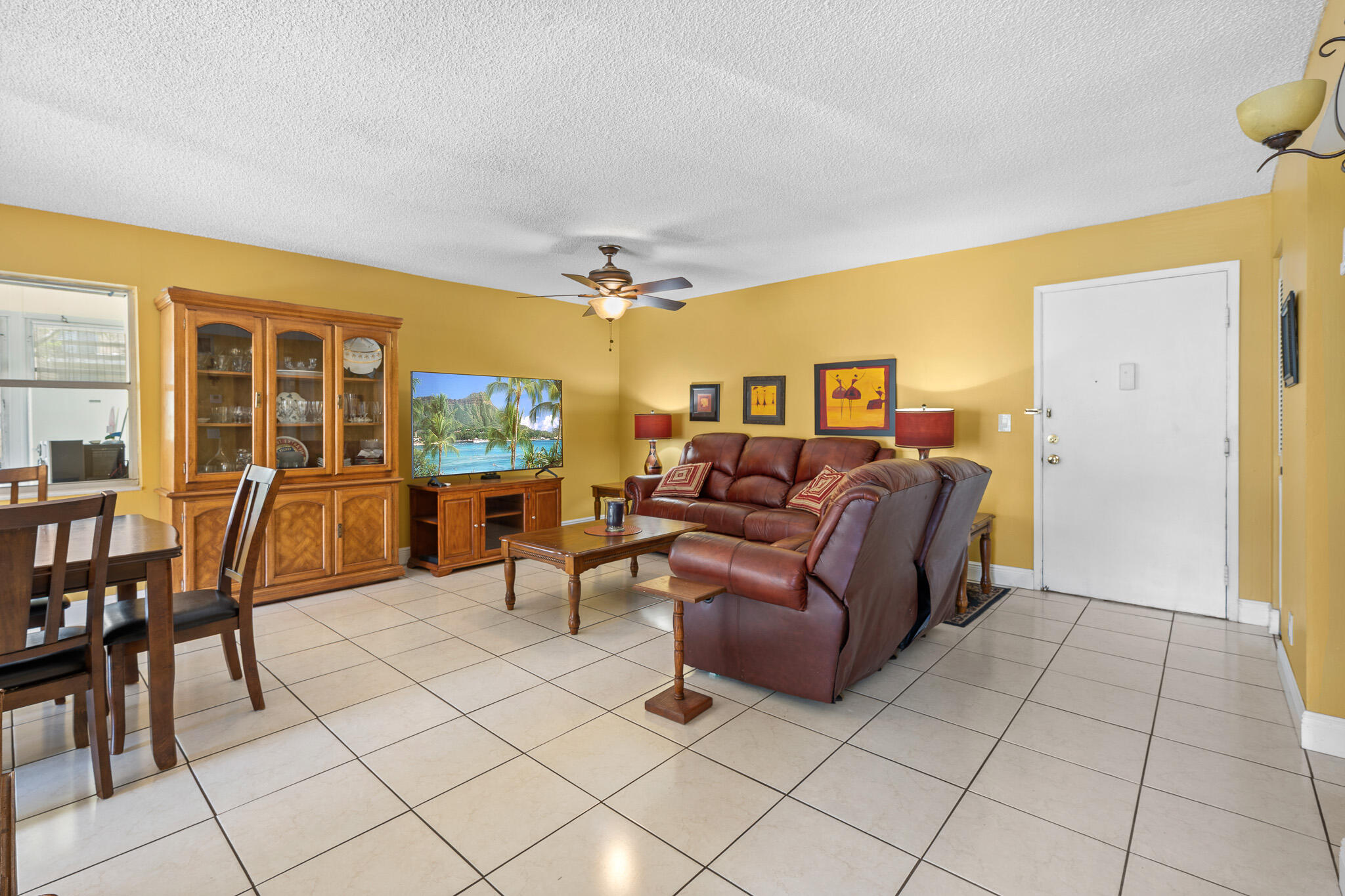 4047 Northwest 16th Street, Unit 206 Lauderhill, FL 33313 - Photo 7 of 26 a living room with furniture and a flat screen tv